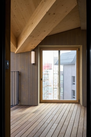 A room with a wooden floor and a glass door