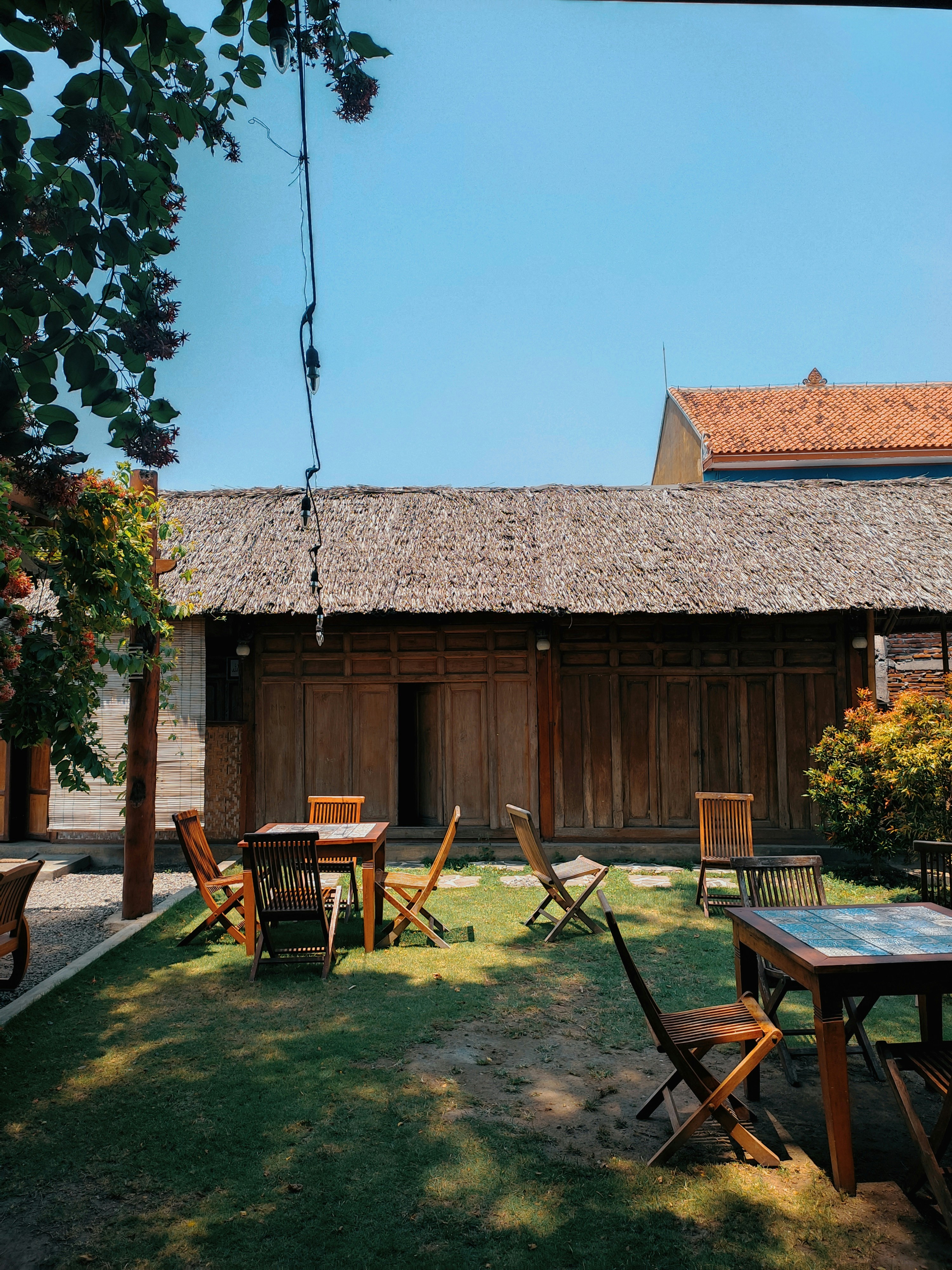 A house with a lawn and a table and chairs