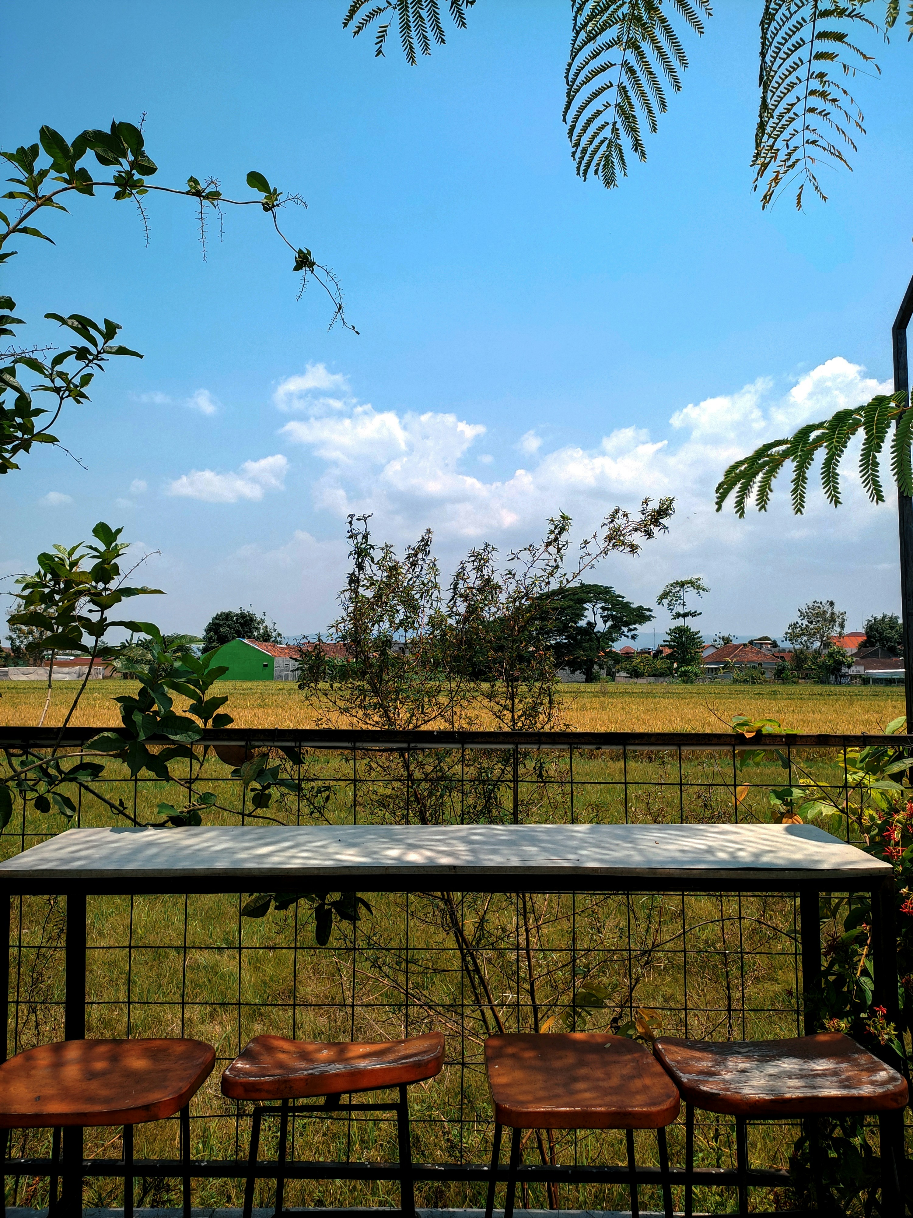 A table and four chairs on a balcony