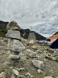 A pile of rocks with a tent in the background