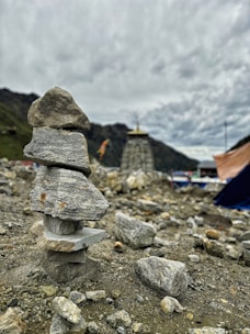 A pile of rocks with a tent in the background