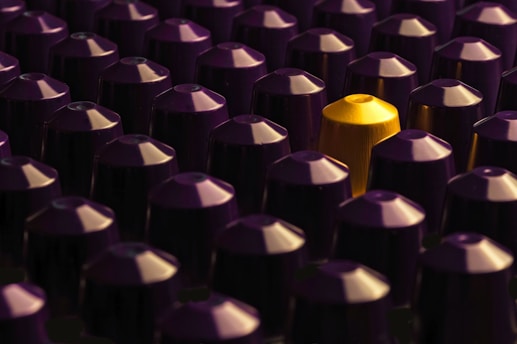 A large group of purple and yellow bullet caps
