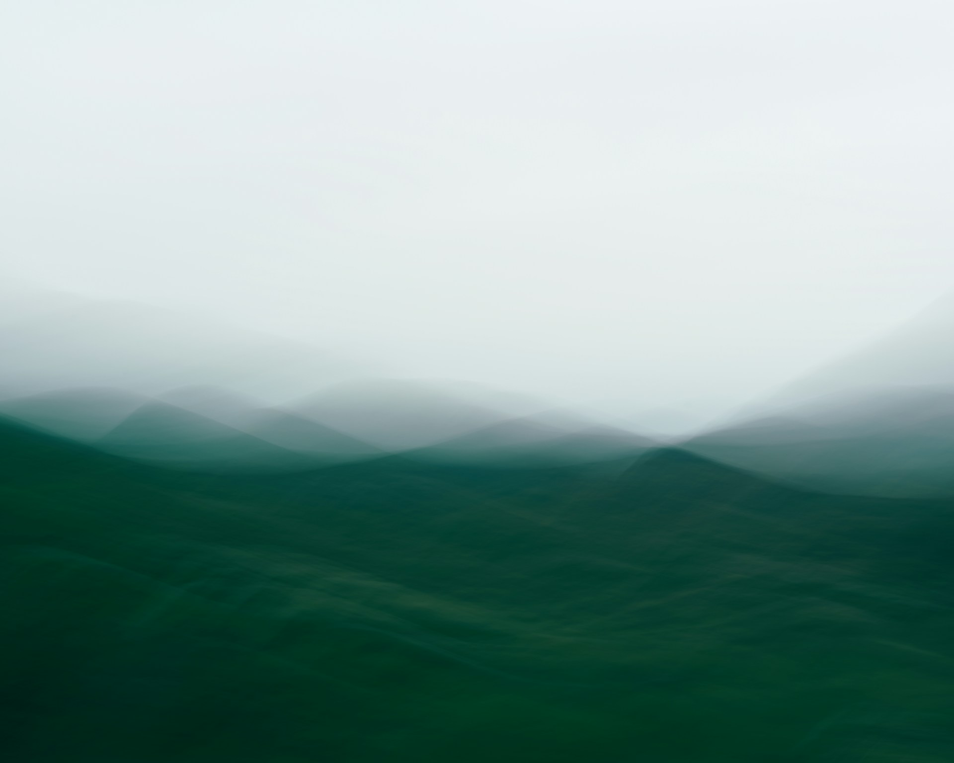 A blurry photo of a wave in the ocean