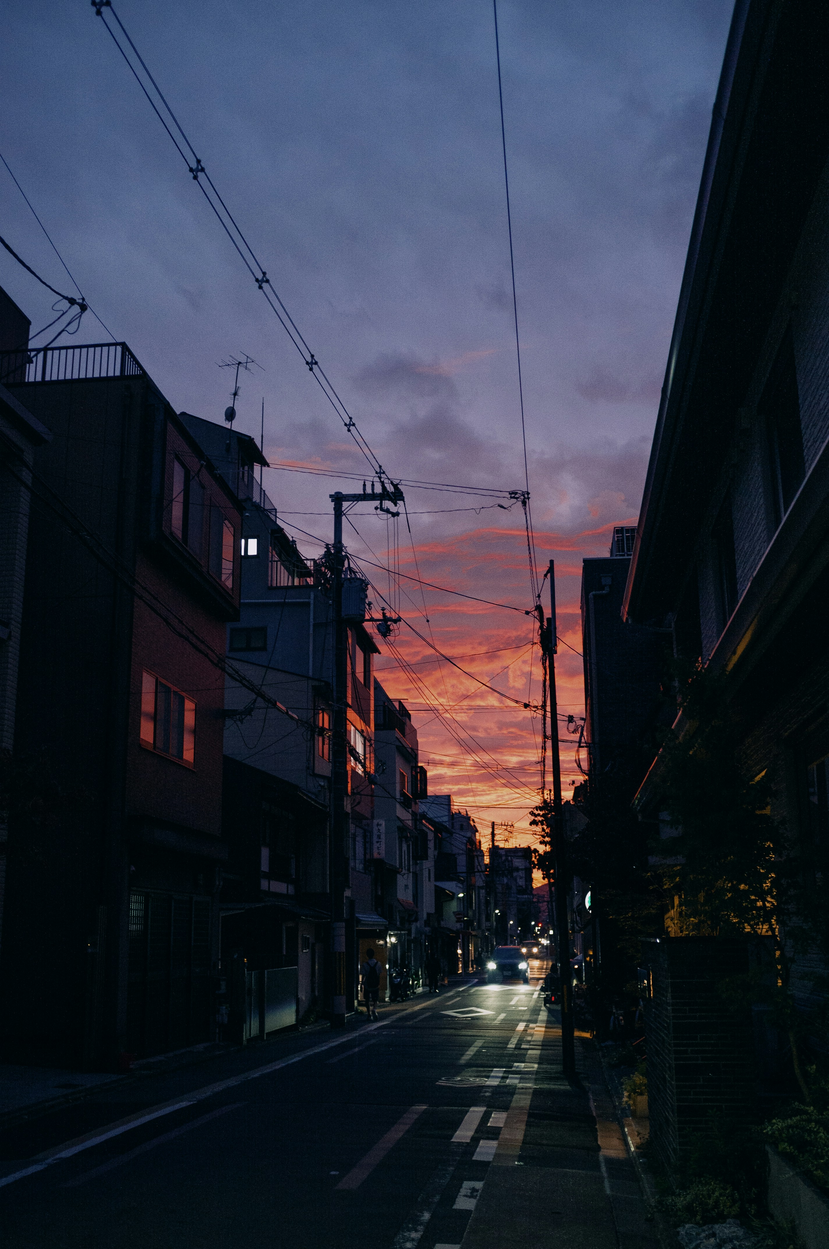 A city street at night with a sky in the background