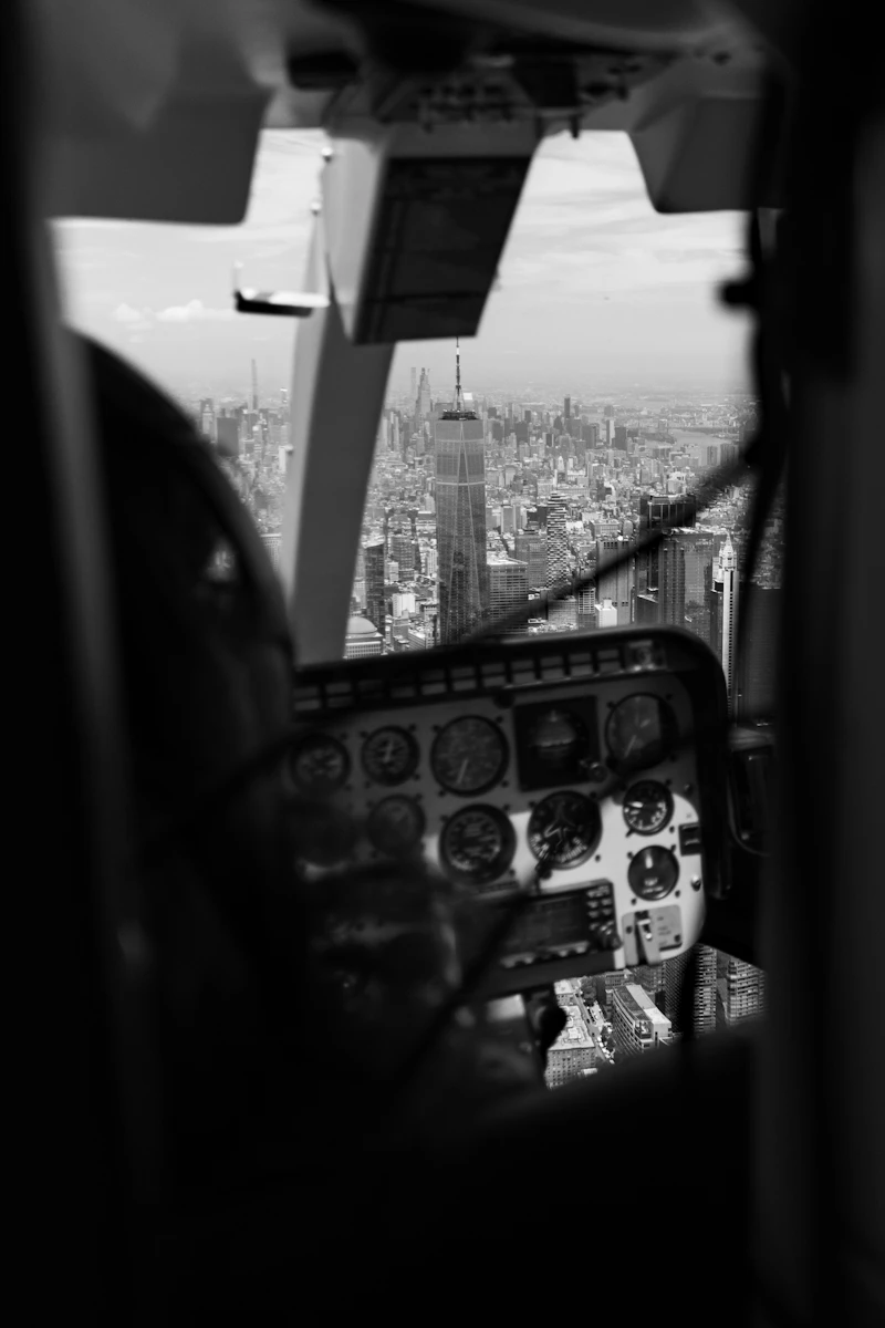 Bell 407 black helicopter in flight over New York