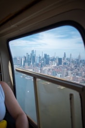 A woman looking out a window at a city