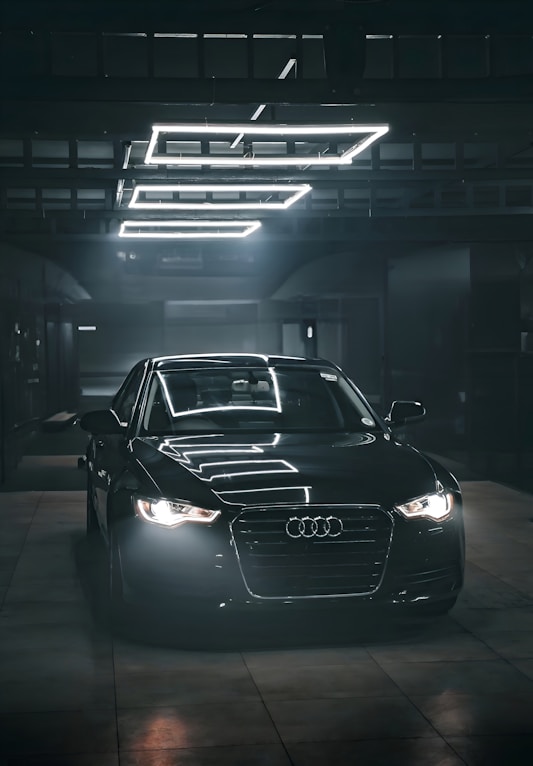 A black car parked in a parking garage