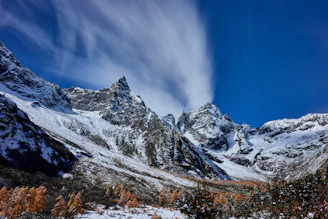 A snow covered mountain range under a blue sky