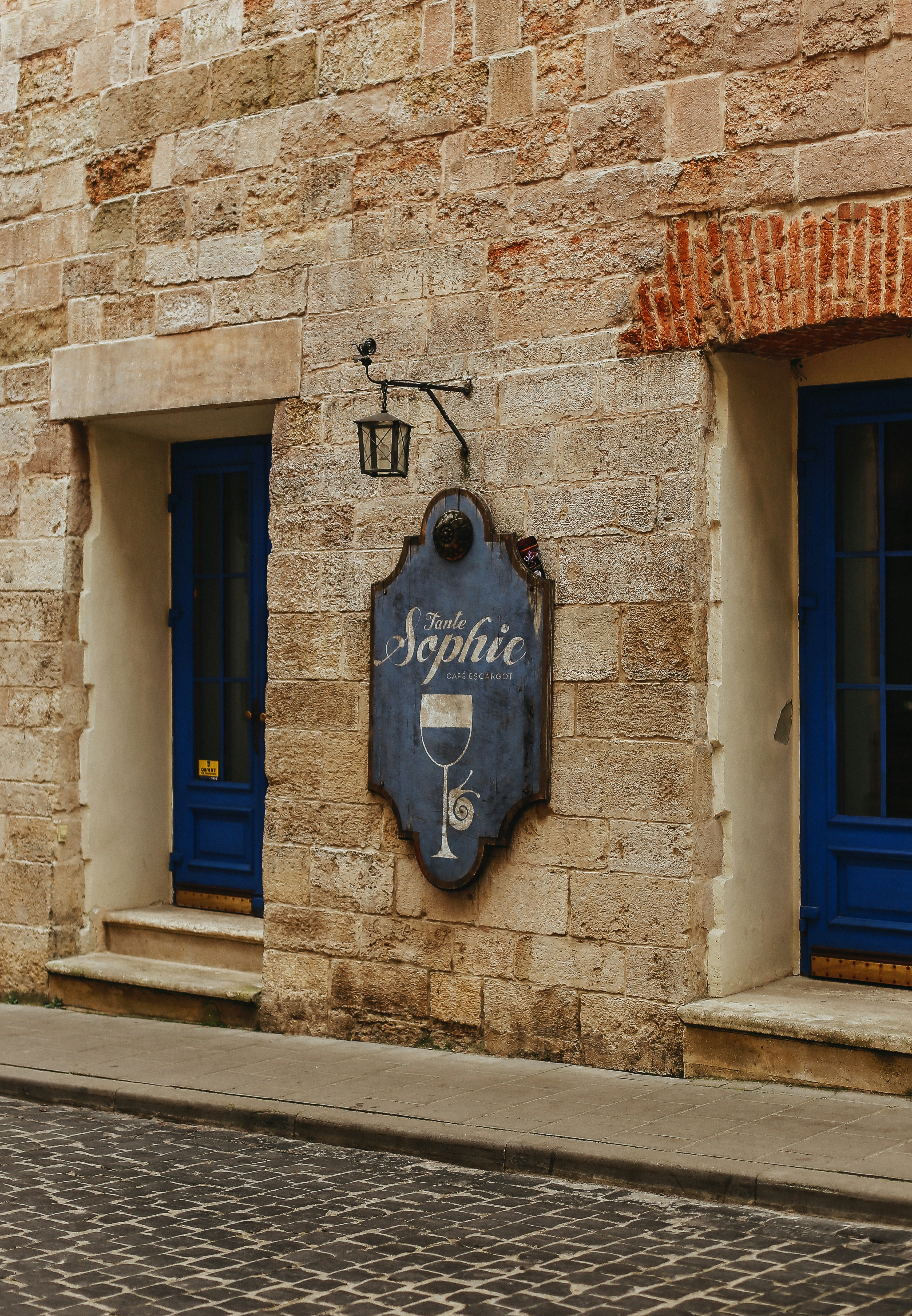 A brick building with blue doors and windows