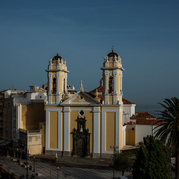 A large yellow and white building with two towers