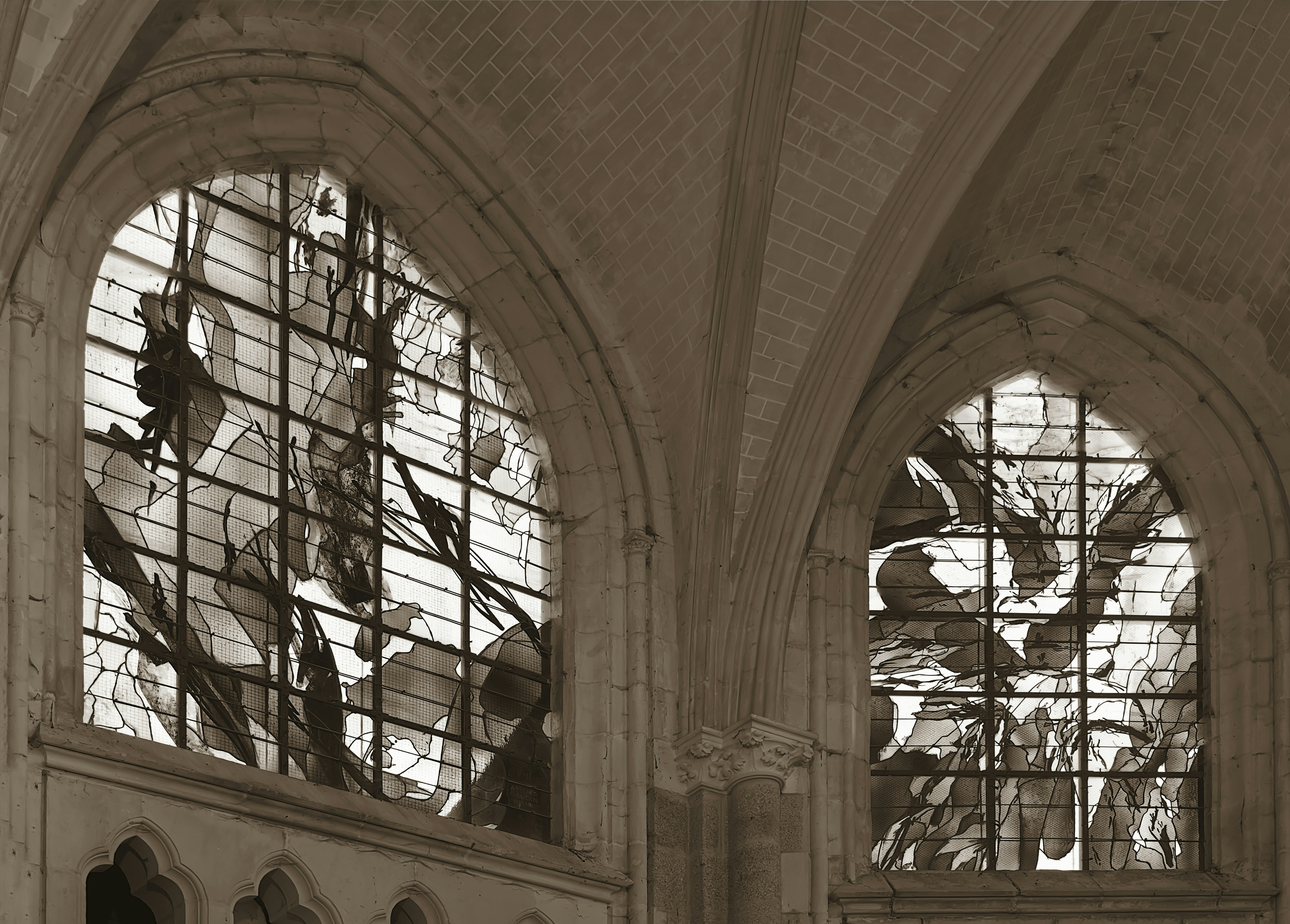 A black and white photo of a church with stained glass windows