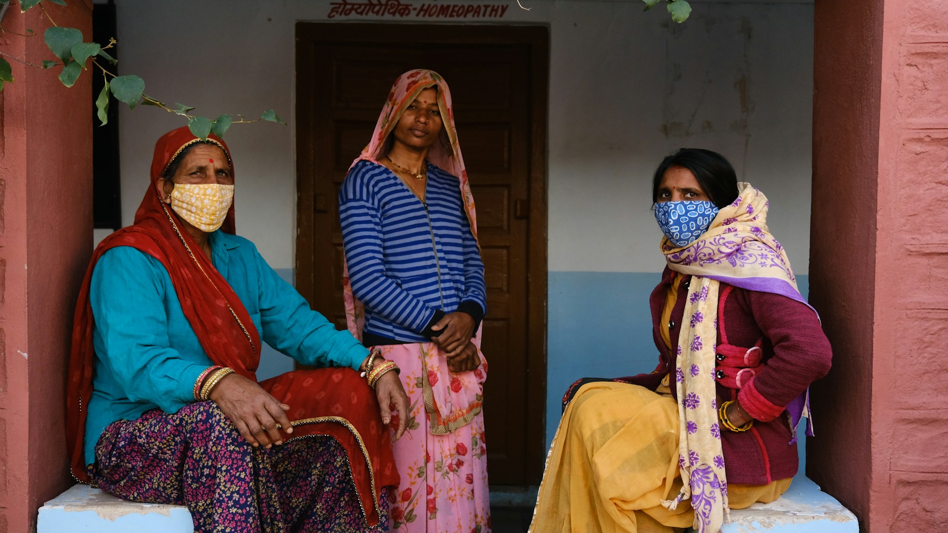 A group of women sitting next to each other