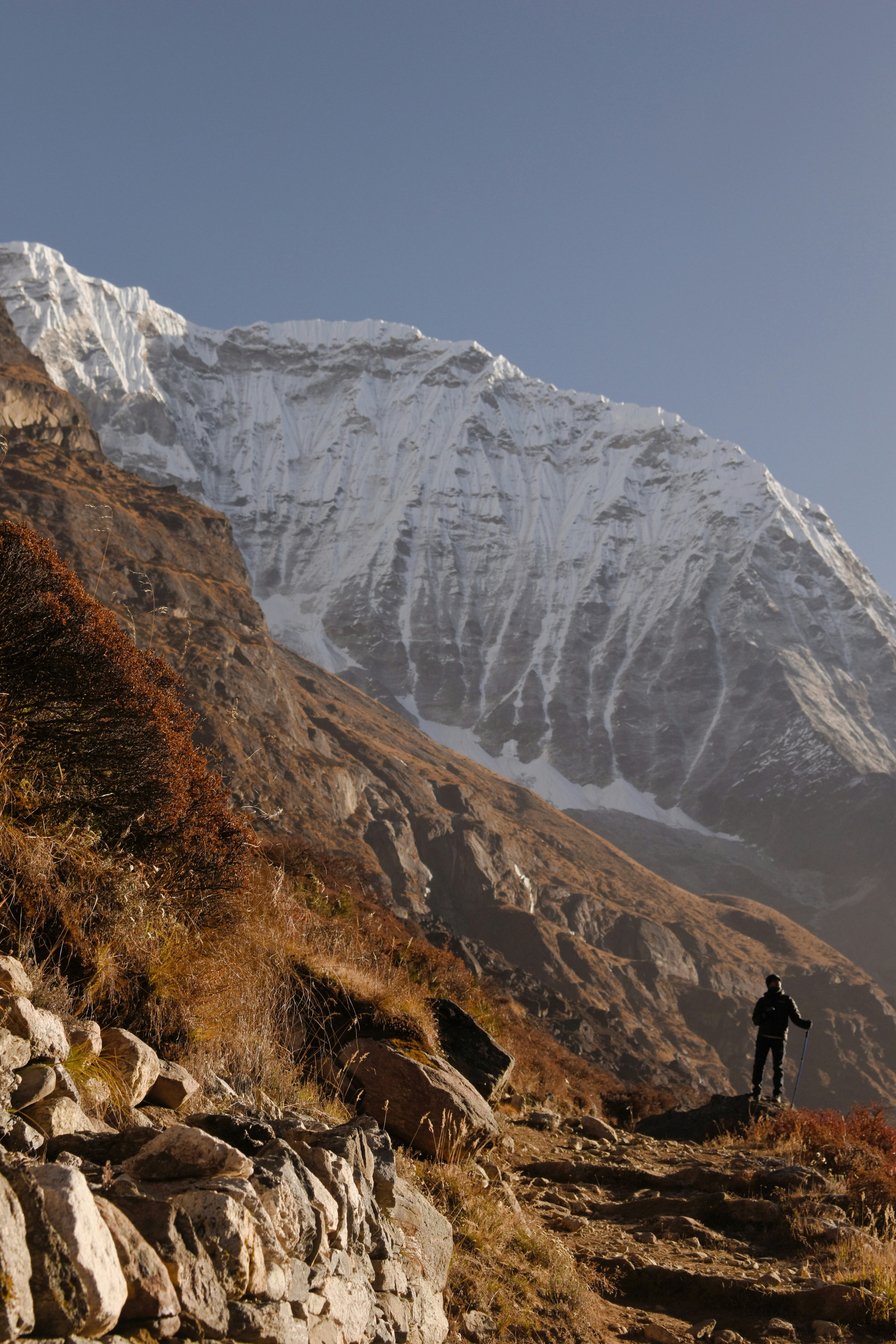 A man hiking up a rocky mountain trail