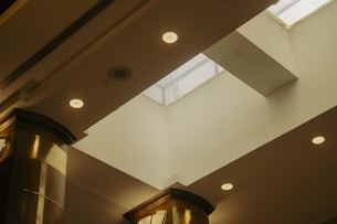 A room with a clock on the wall and a skylight