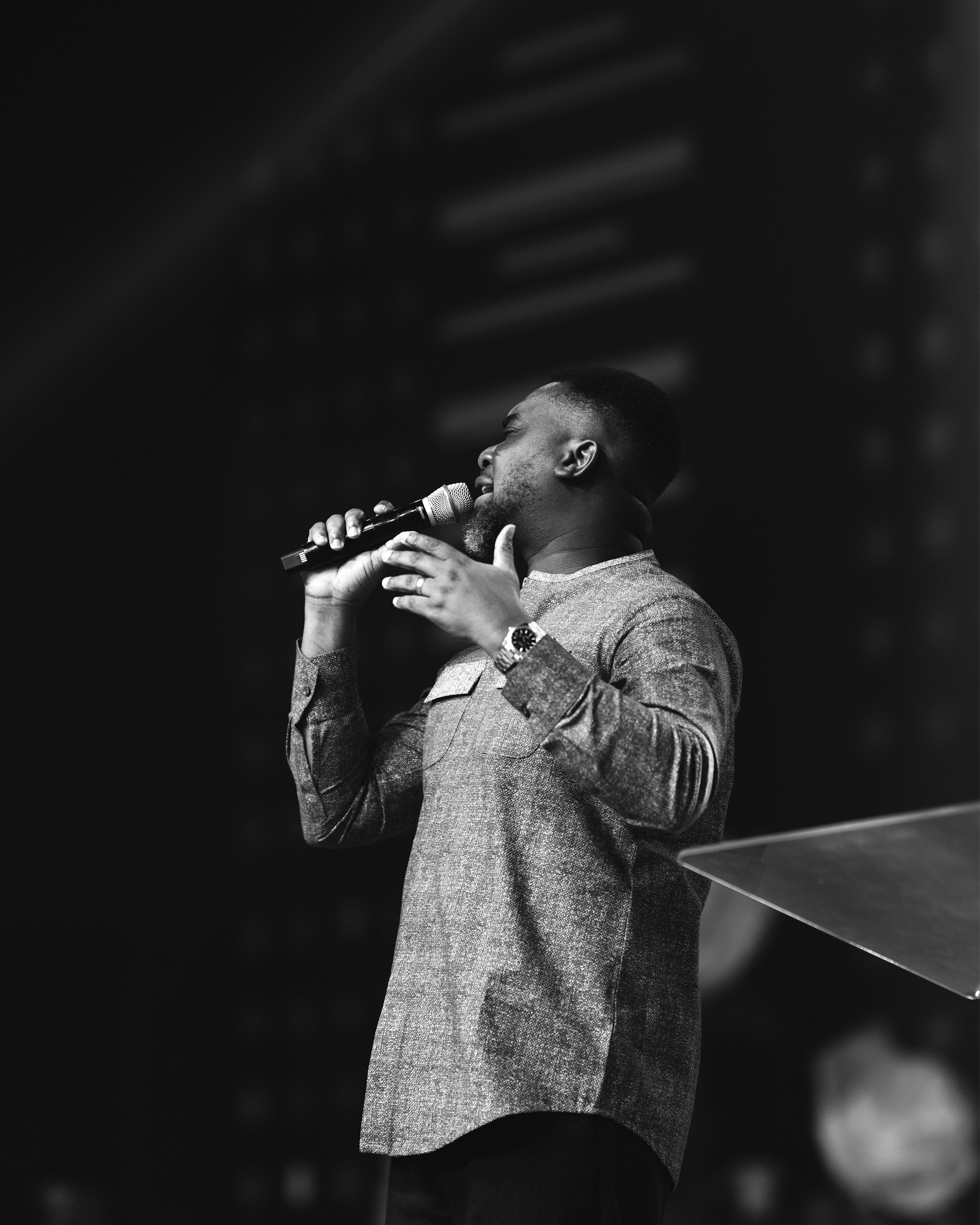 A man standing on a stage holding a microphone