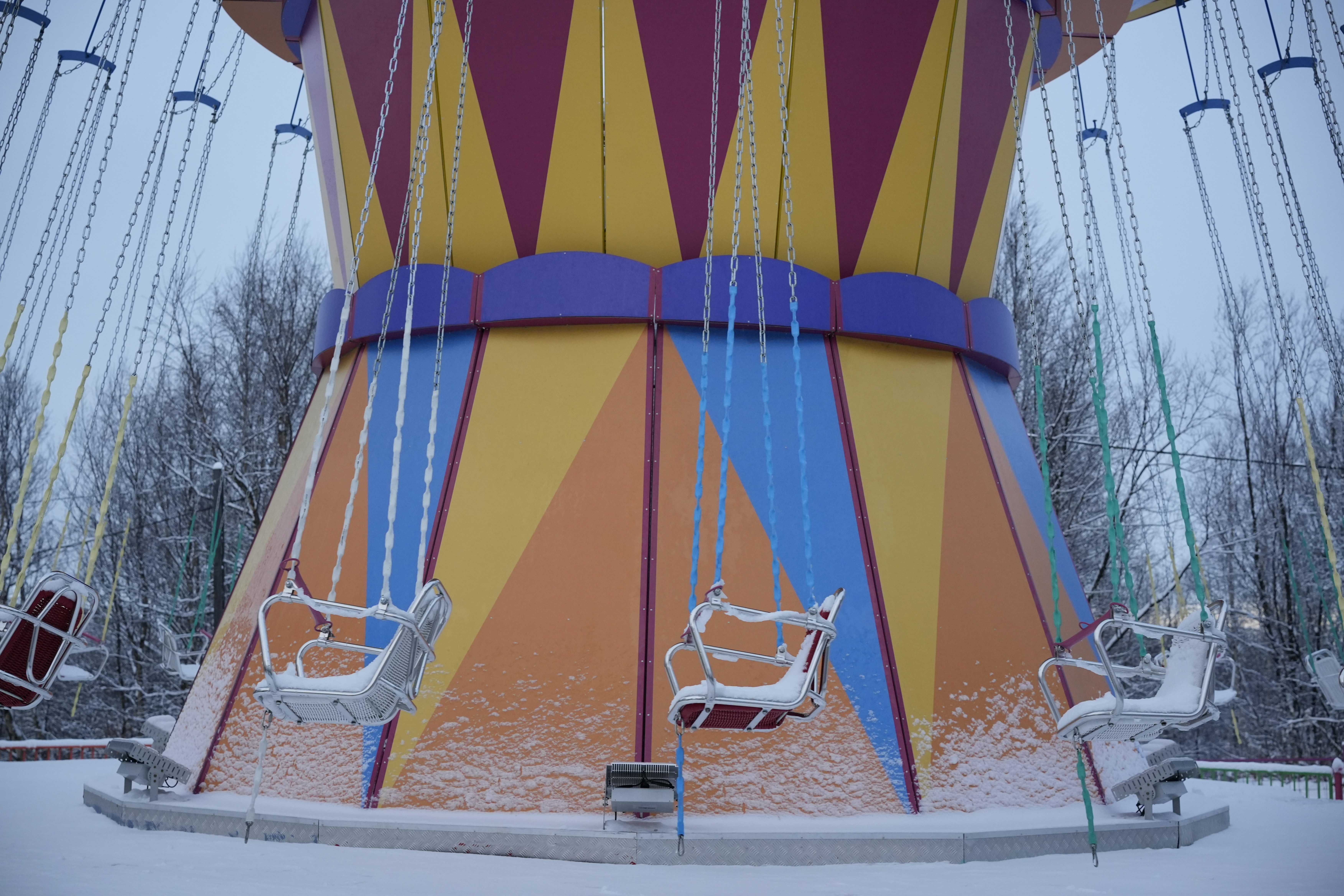 A carnival ride in the middle of a snow covered field