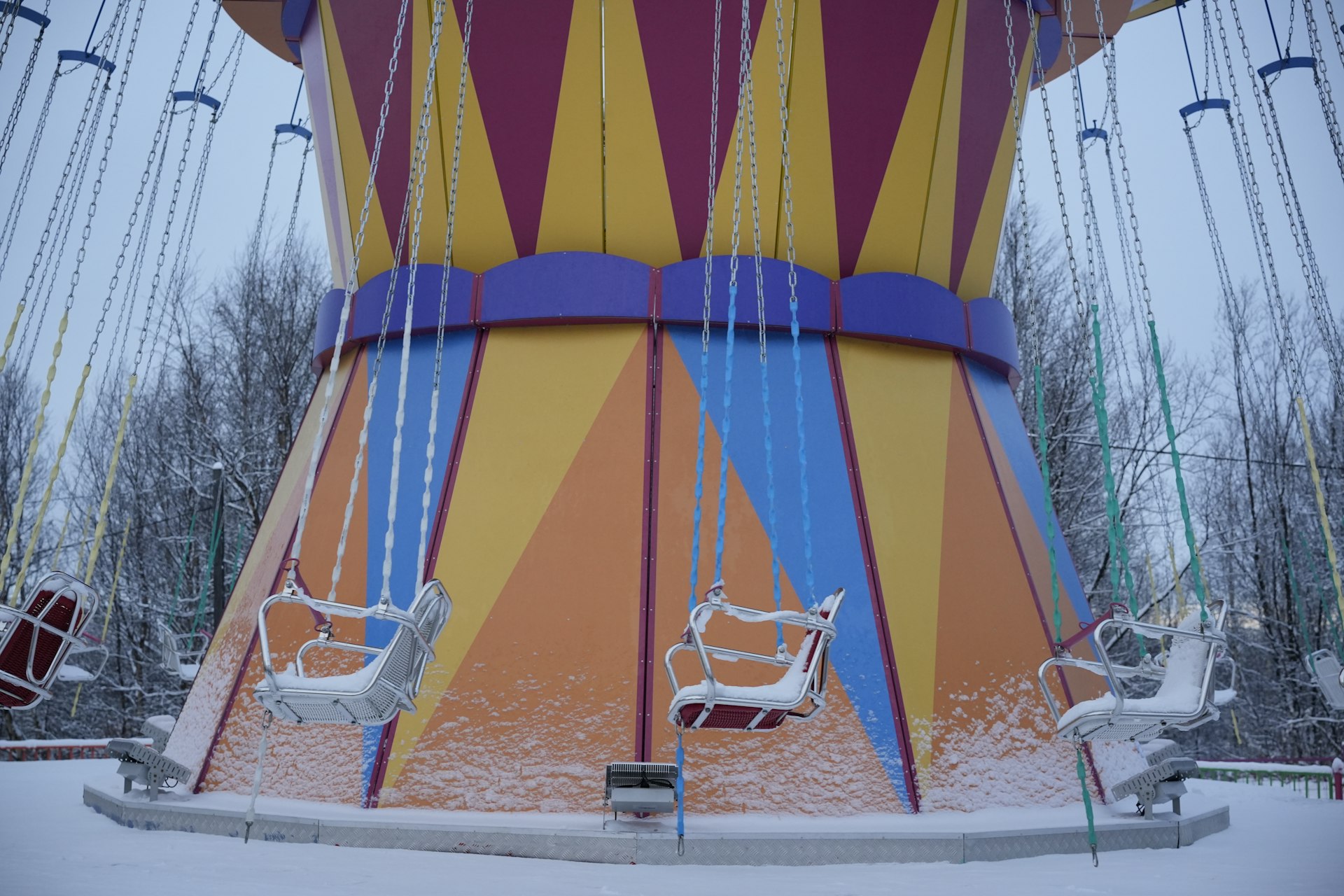 A carnival ride in the middle of a snow covered field