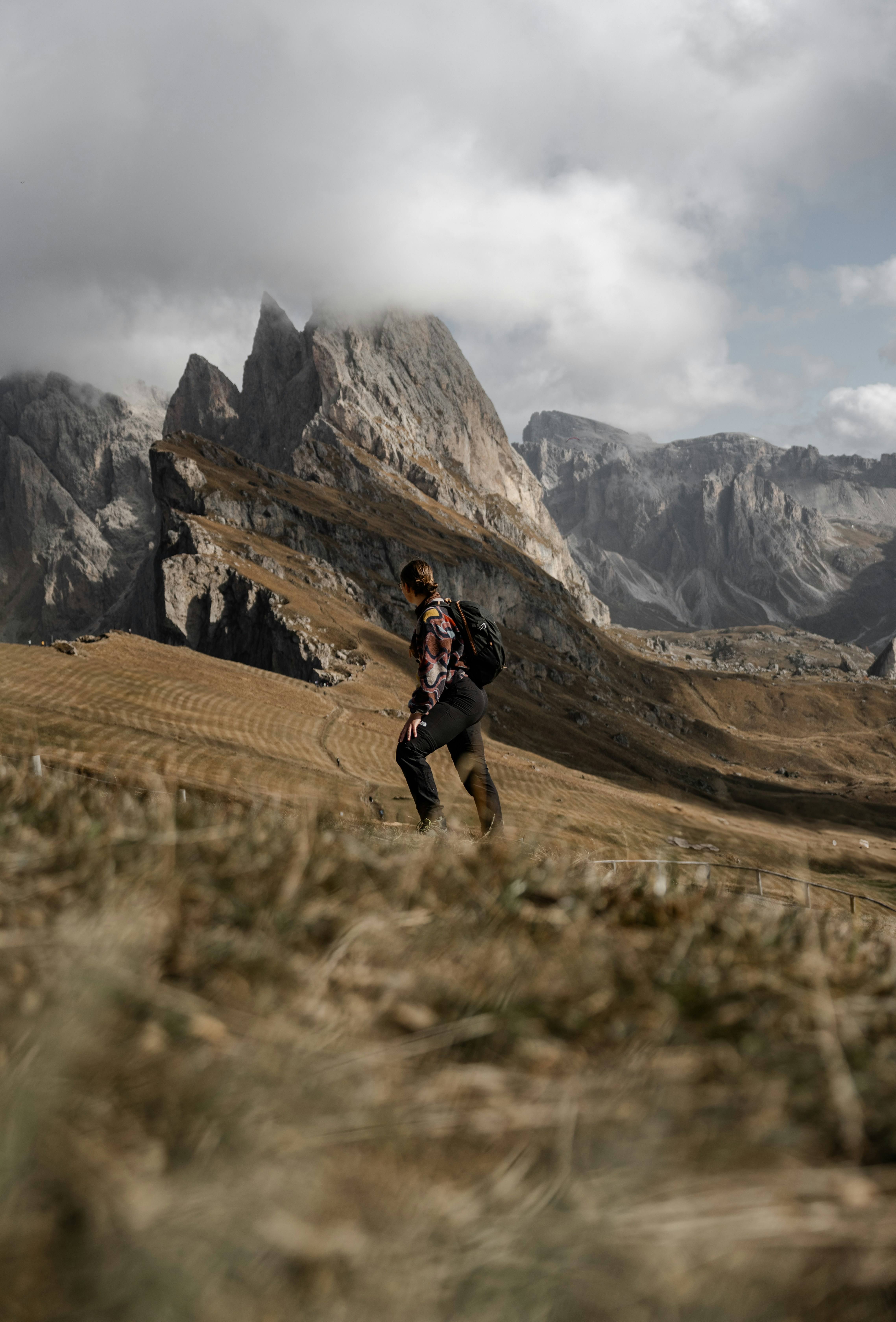 A man walking across a grass covered field