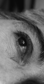 A black and white photo of a man's eye