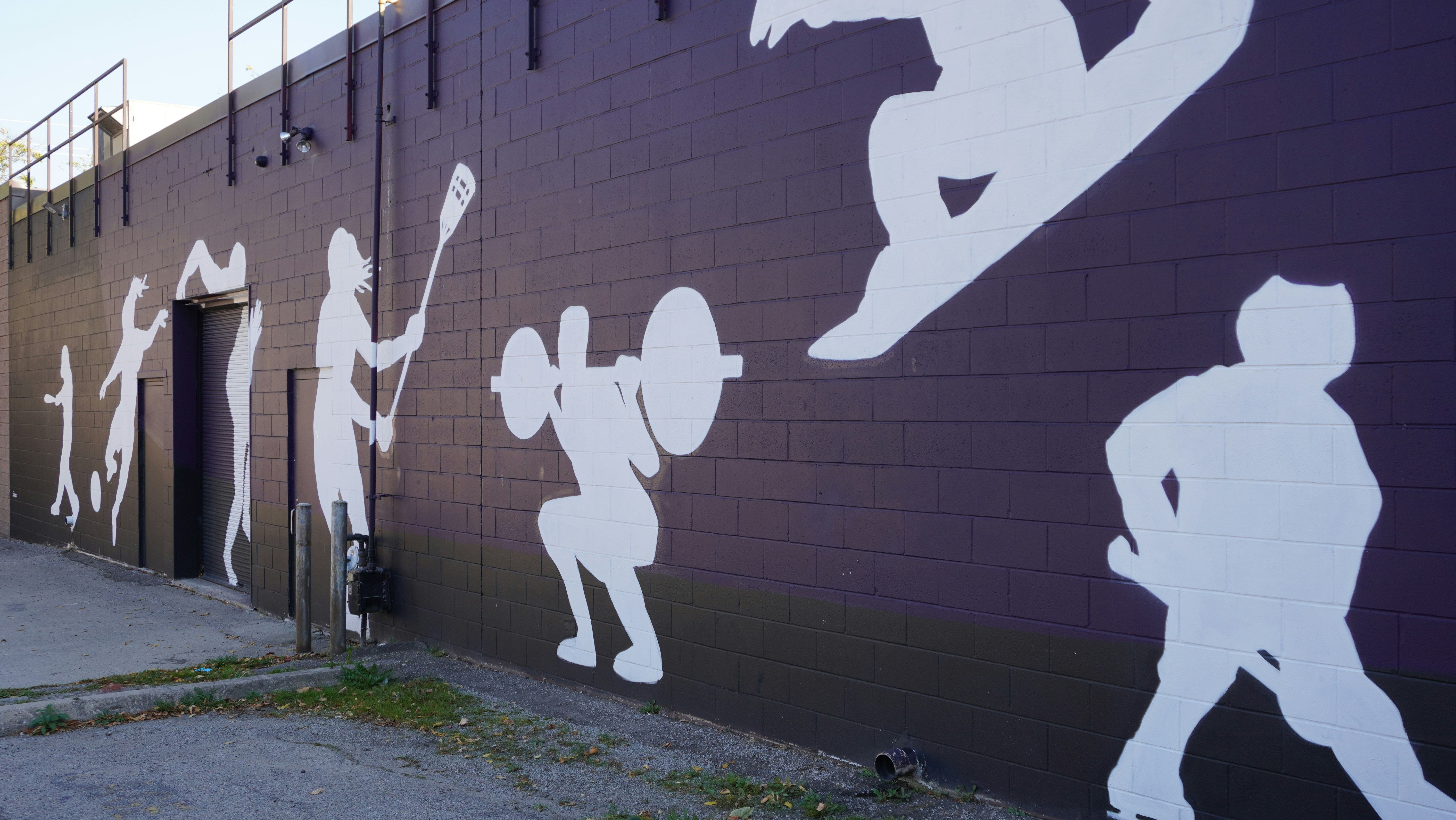 A mural of a baseball player painted on the side of a building