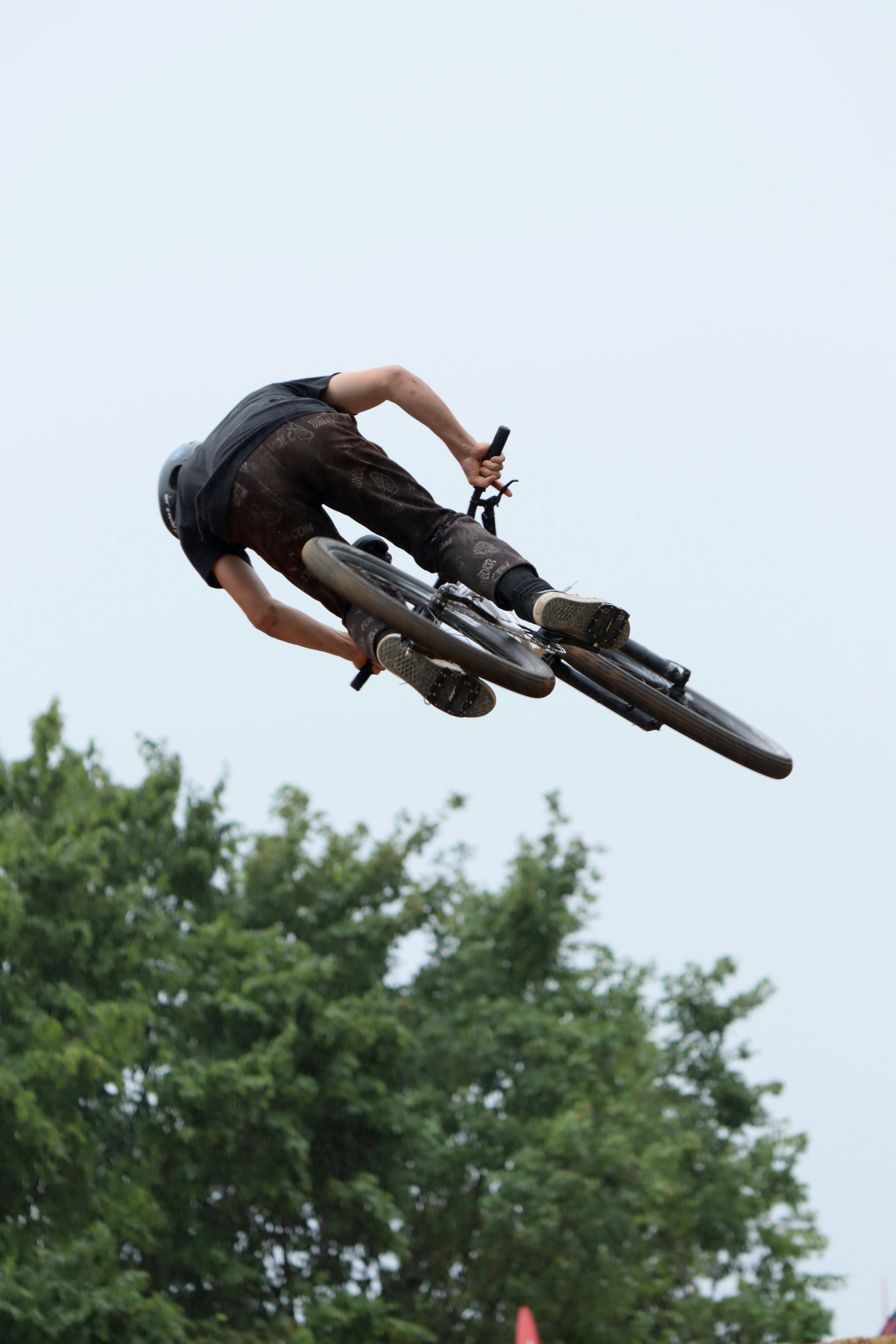 A man flying through the air while riding a bike