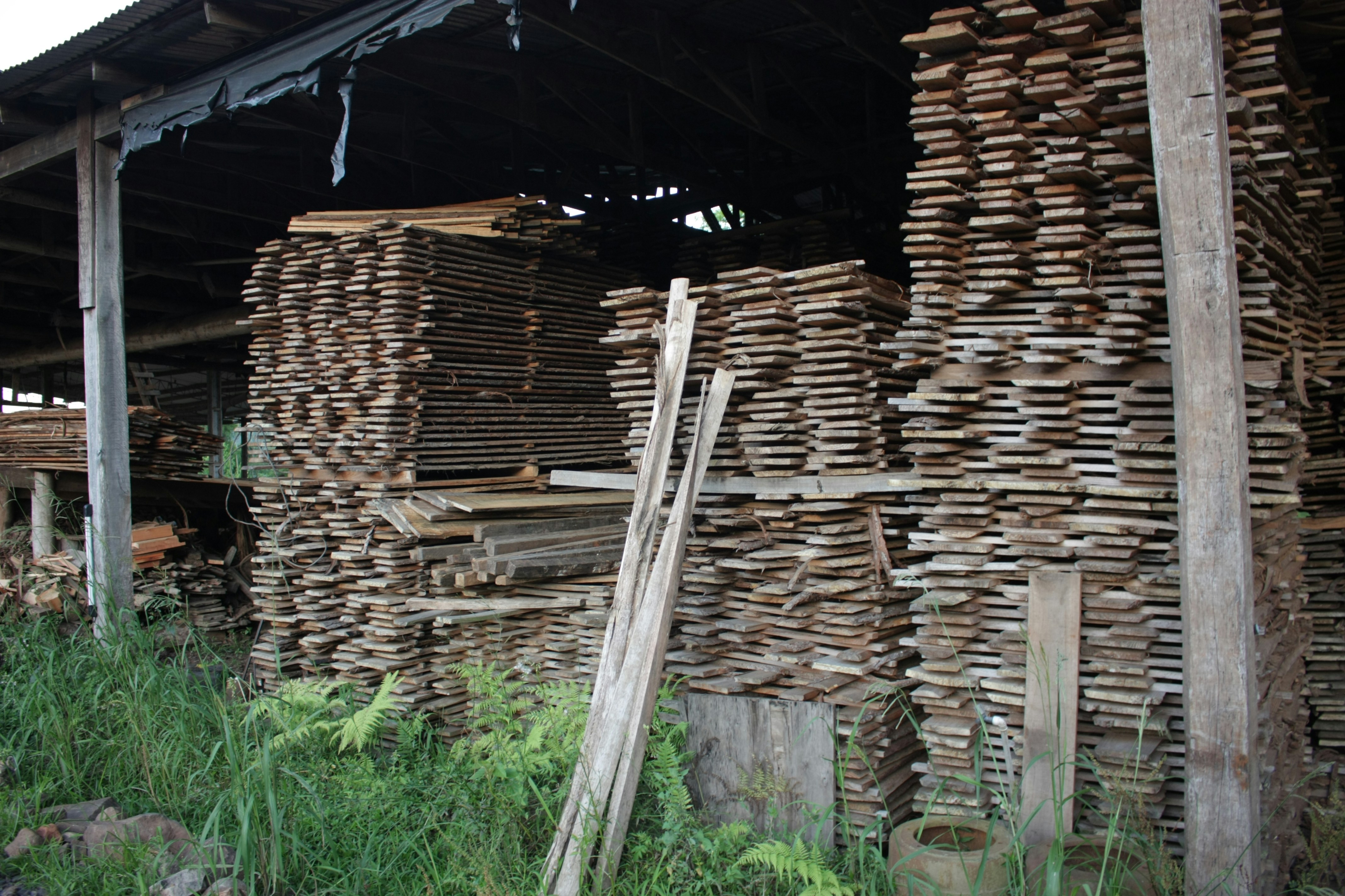 A pile of wood sitting next to a building