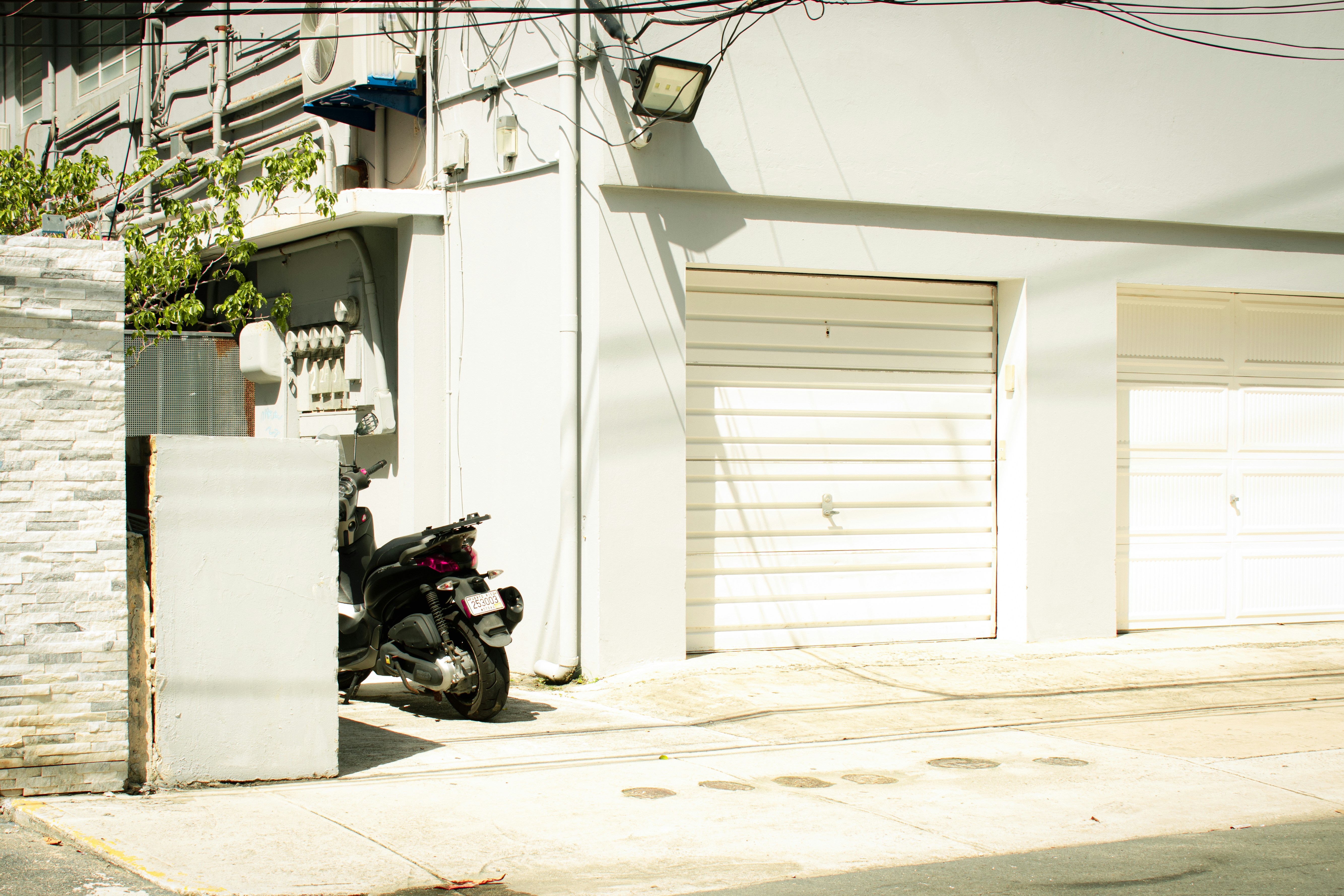 A motorcycle parked in front of a white building