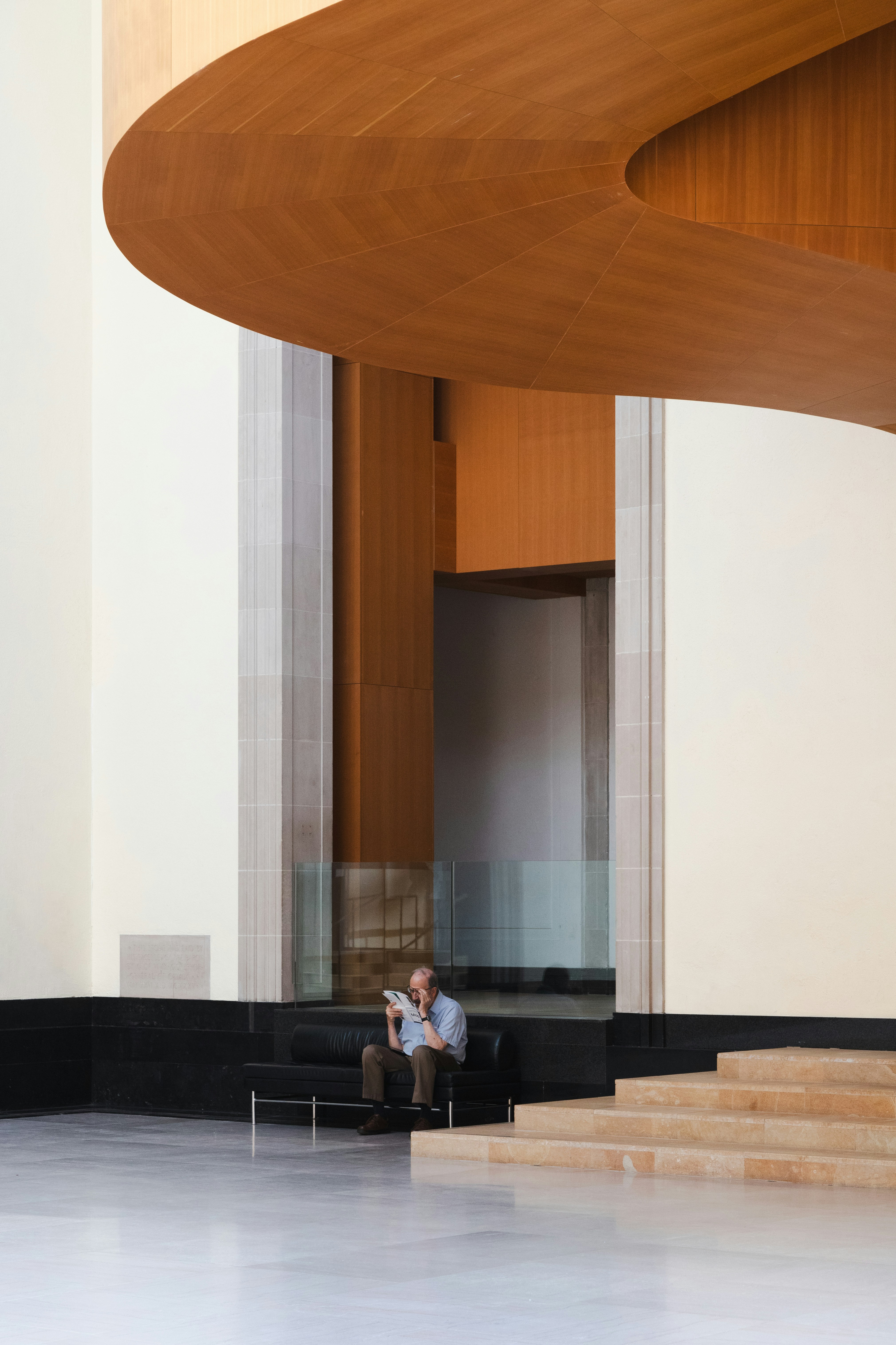 A man sitting on a chair in a large room