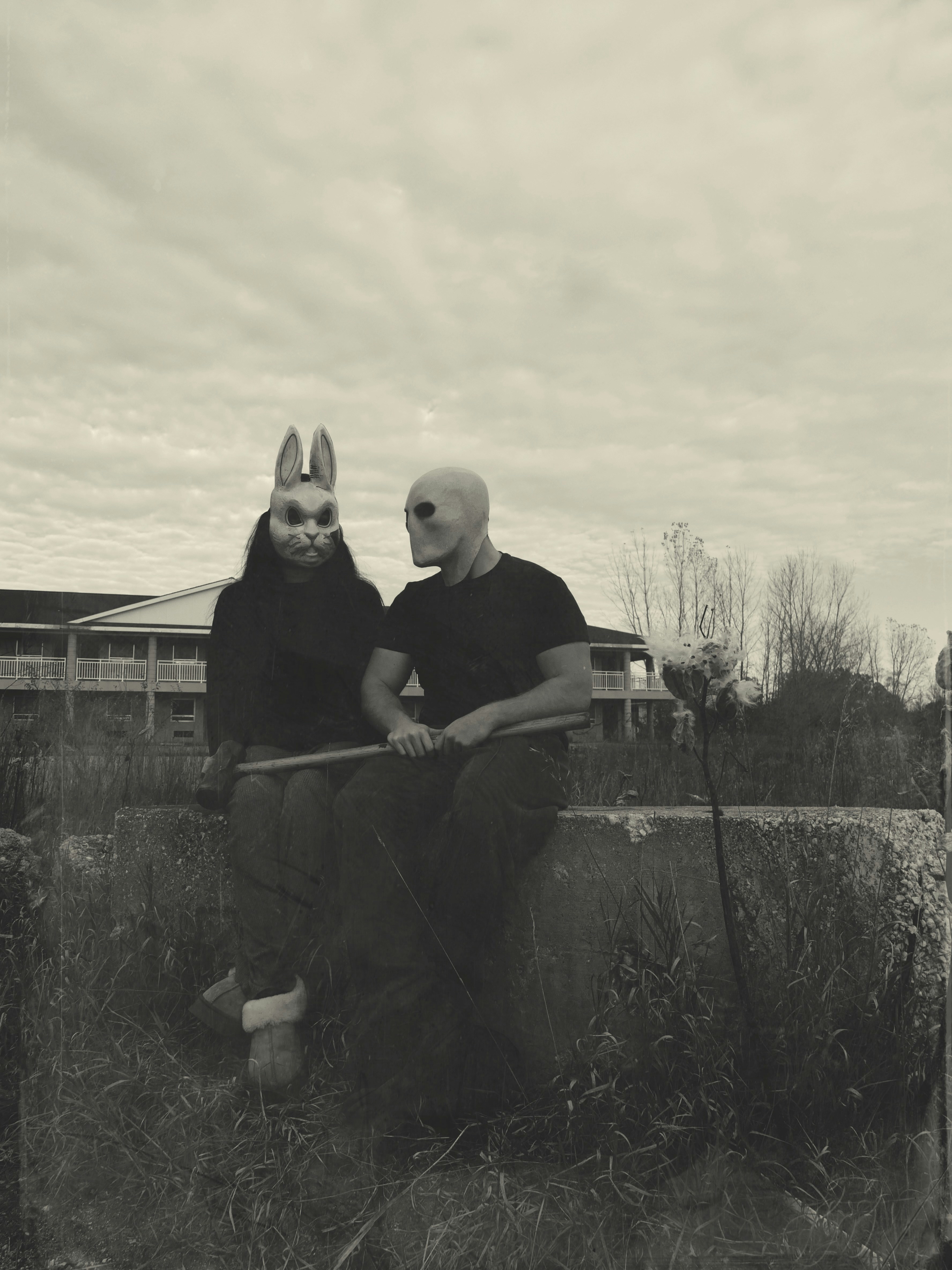 A man and a woman are sitting on a wall