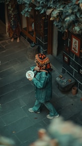 A person walking down a street holding a frisbee