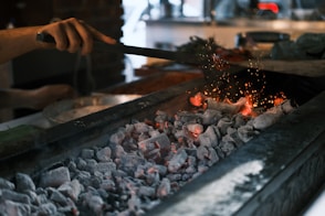 A person is cooking something on a grill