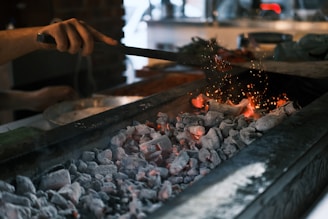 A person is cooking something on a grill