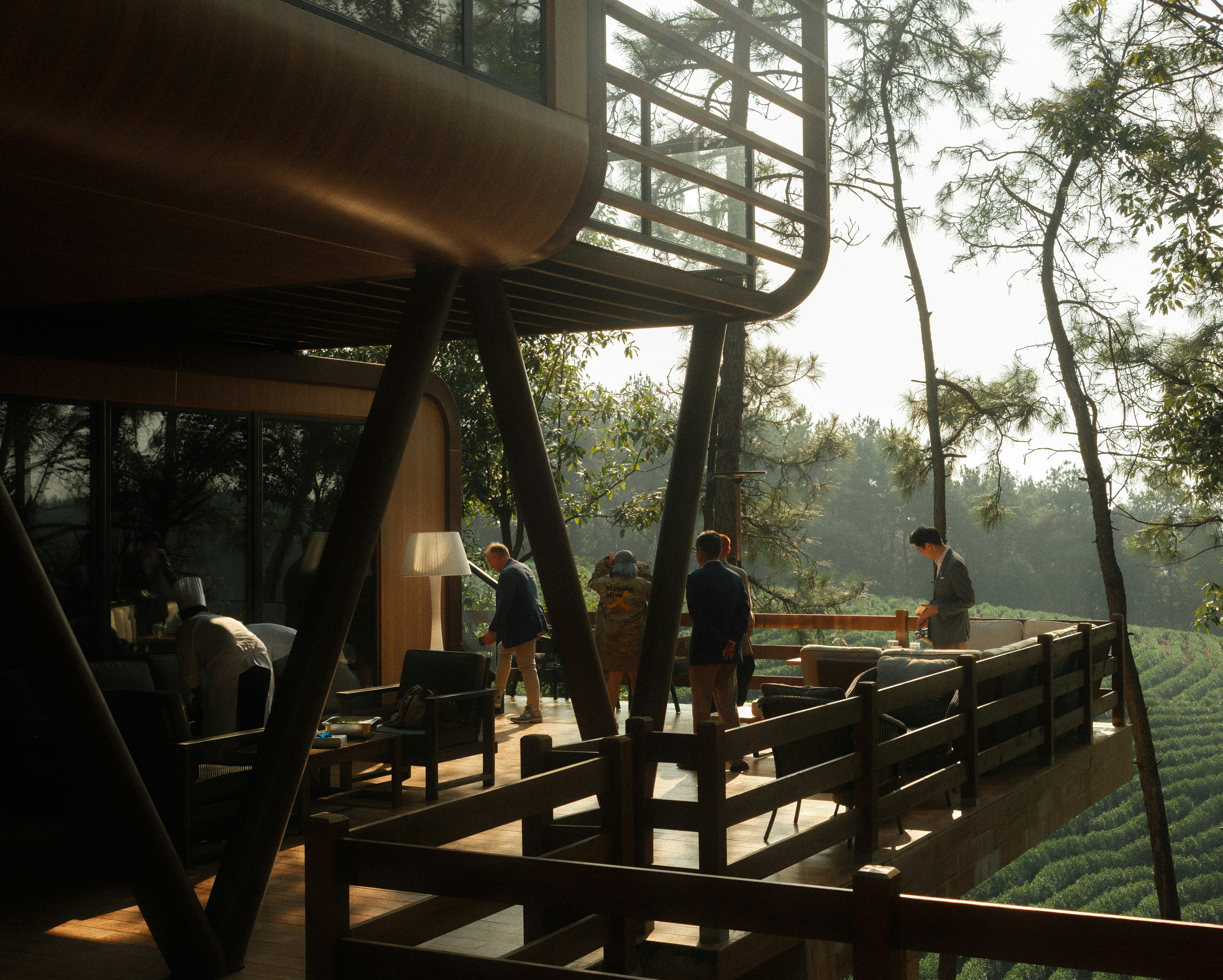 A group of people standing on top of a wooden bridge