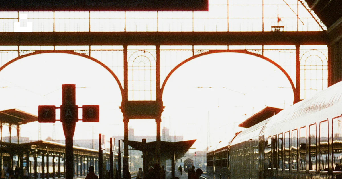 A train station with people walking on the platform photo – Free Human ...