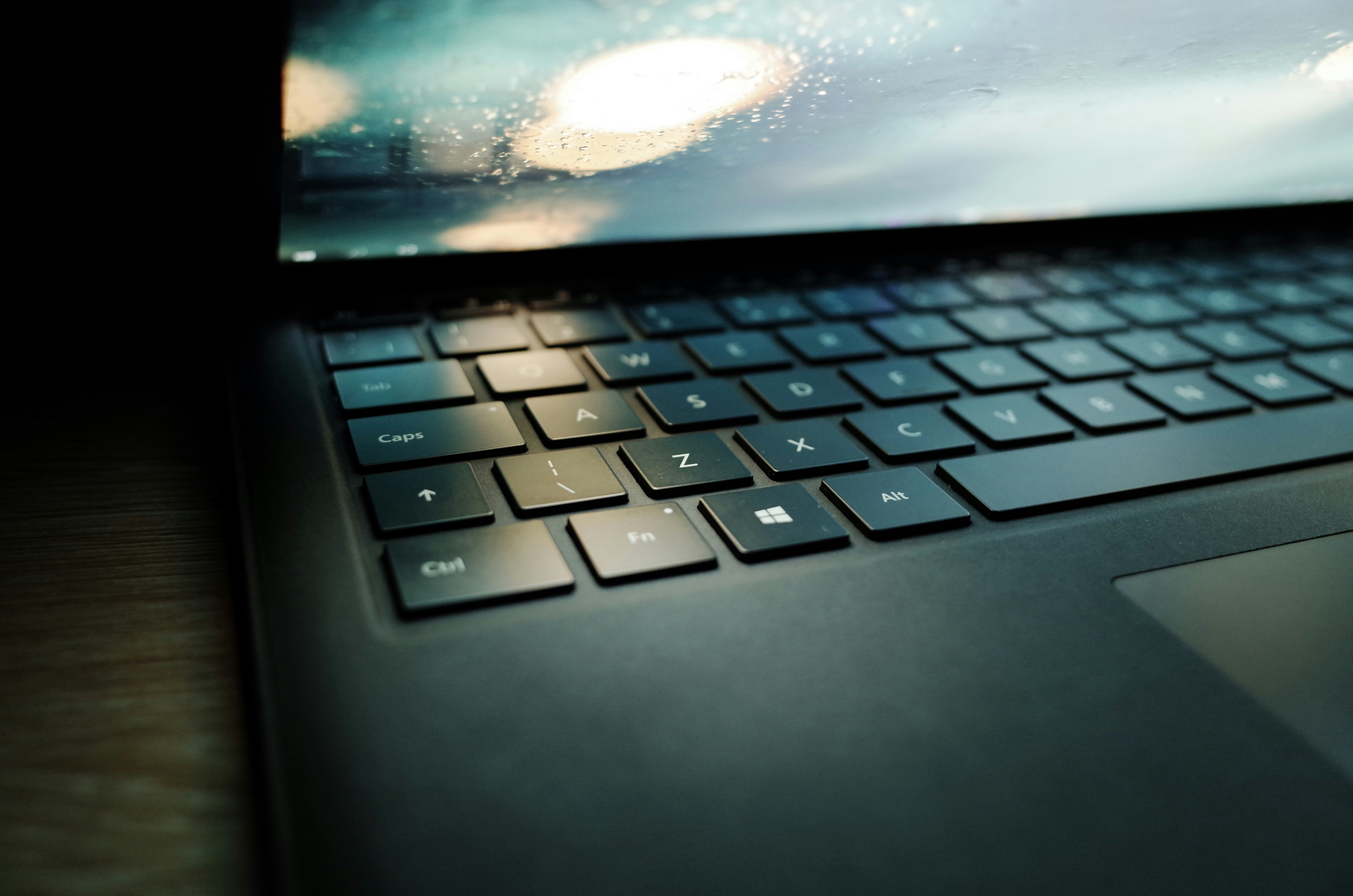 Un ordenador portátil encima de una mesa de madera