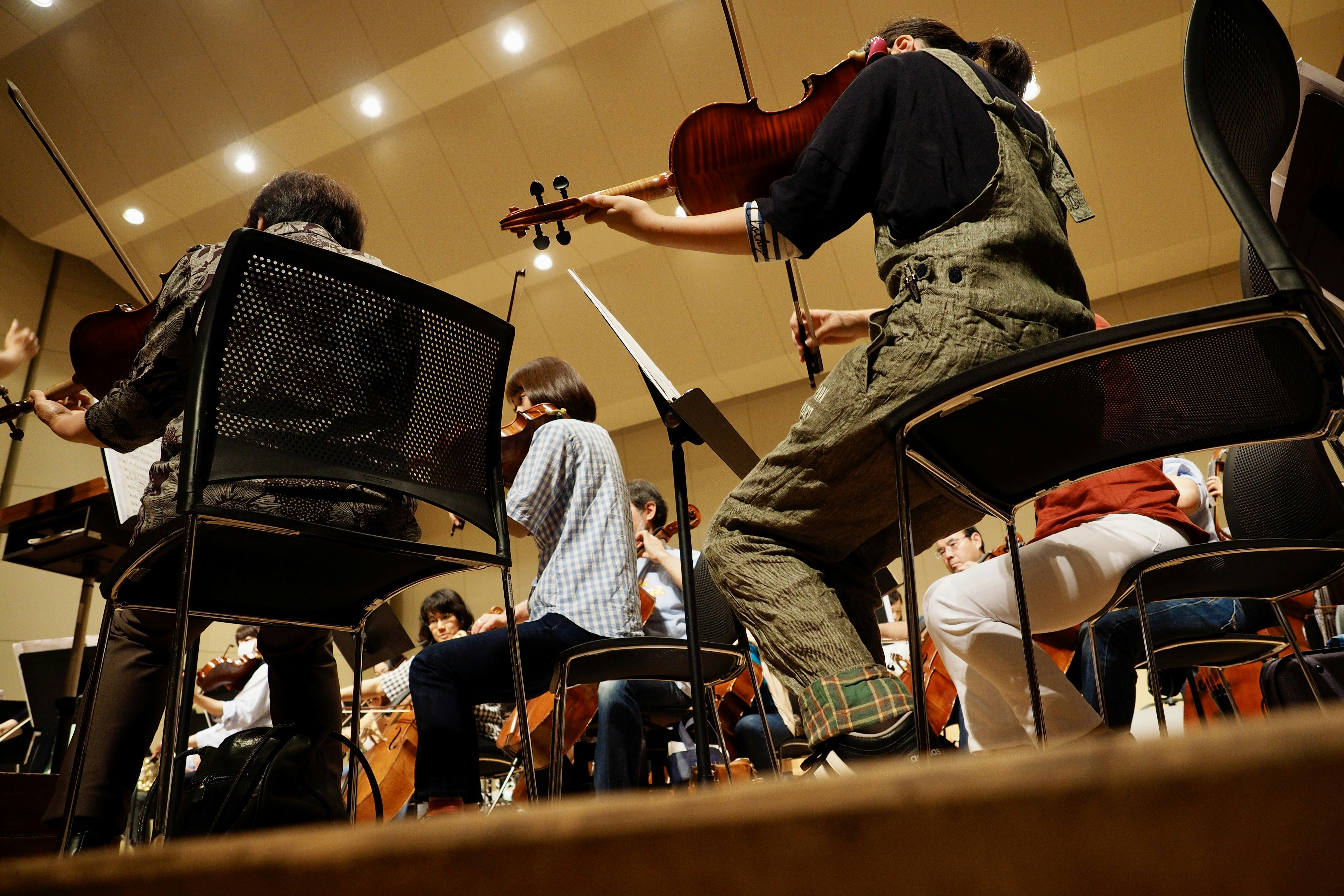 A group of people playing musical instruments in a room