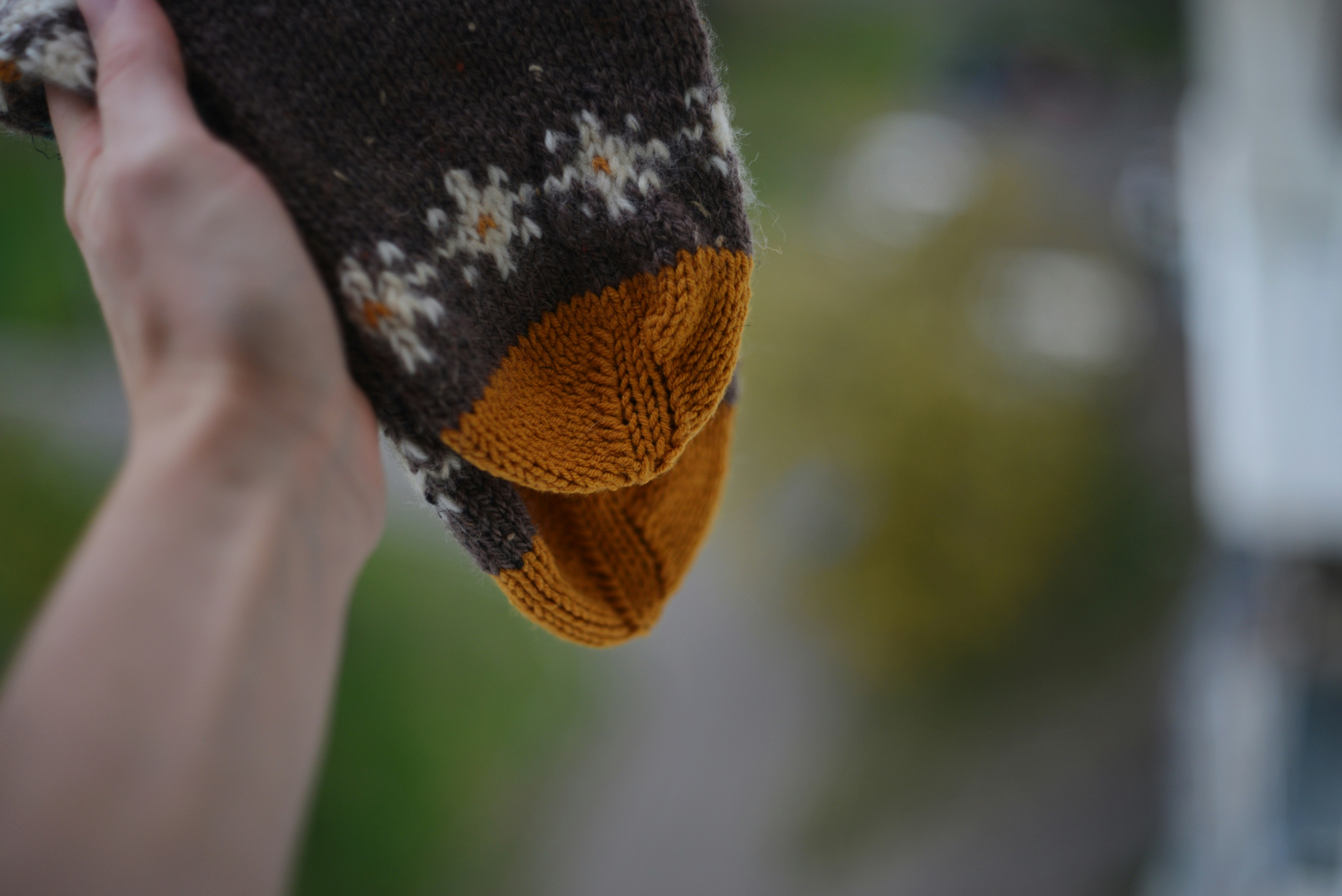 A person holding a piece of food in their hand