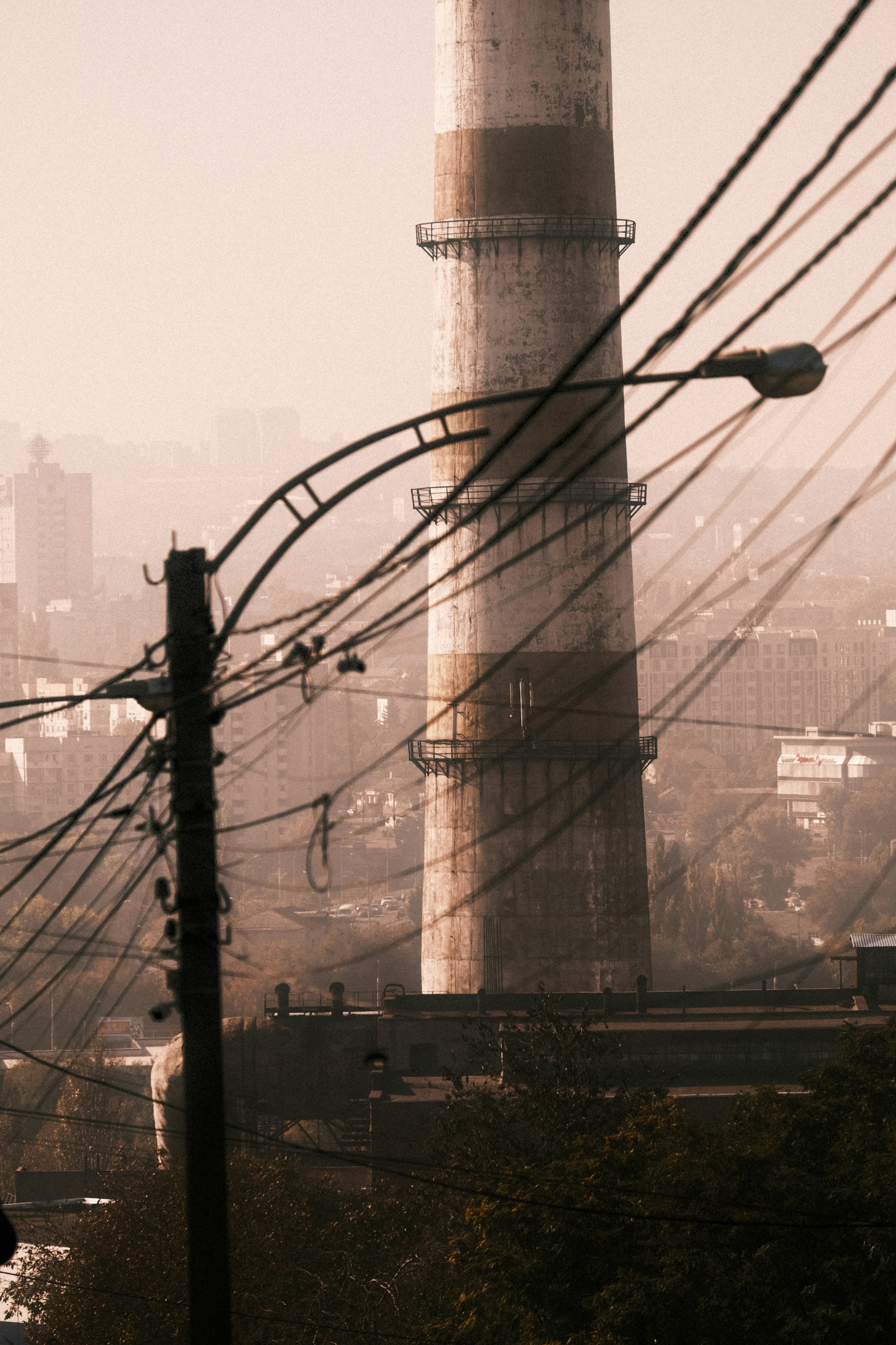 A view of a power plant and power lines in the foreground