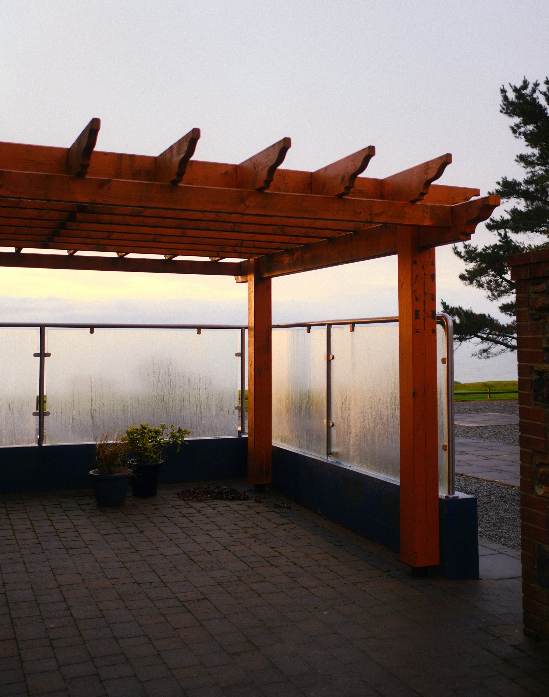 A pergolated area with a view of the ocean