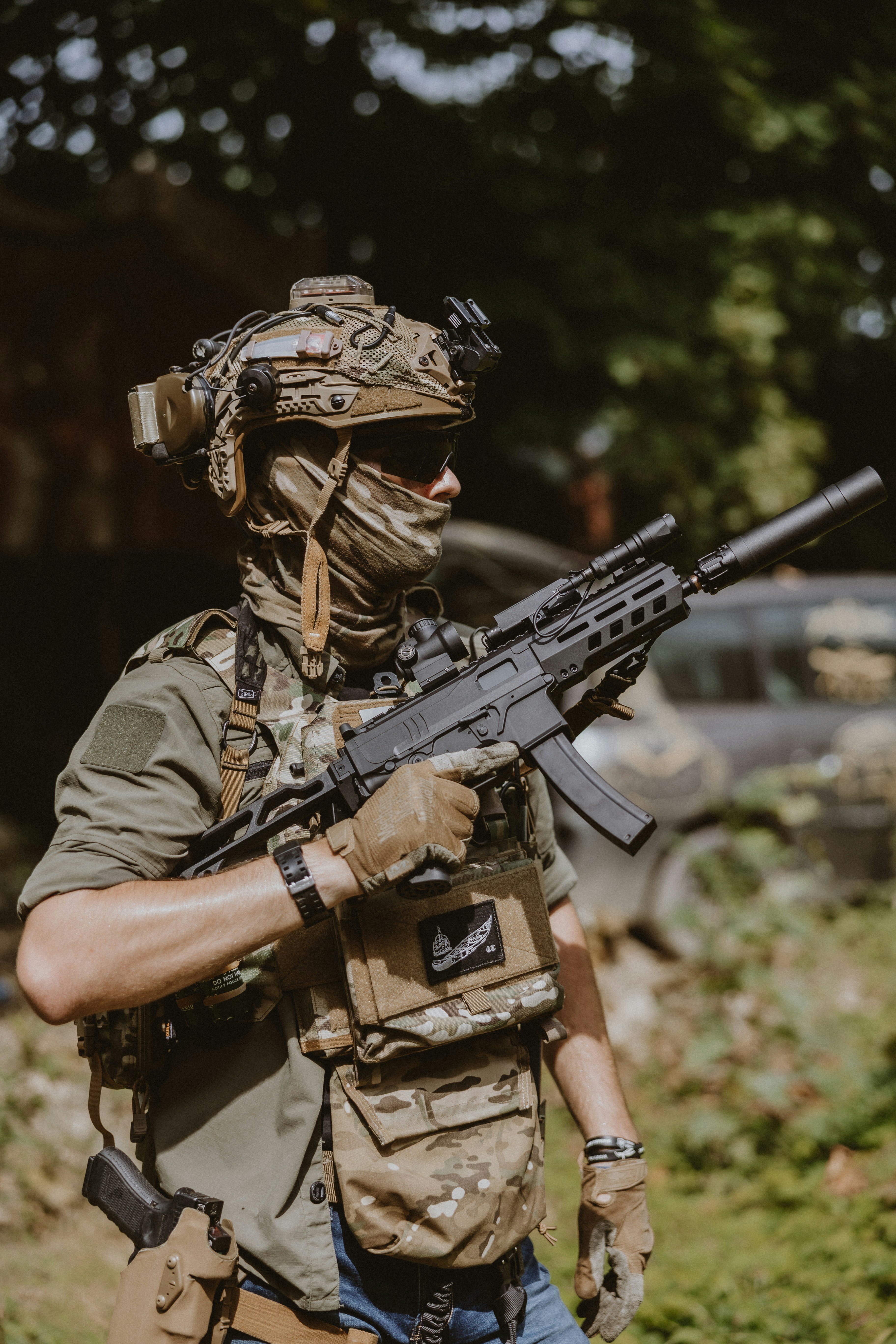 A man in camouflage holding a rifle in his hand
