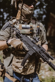 A man wearing a mask and holding a rifle