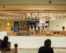A group of people sitting in front of a store