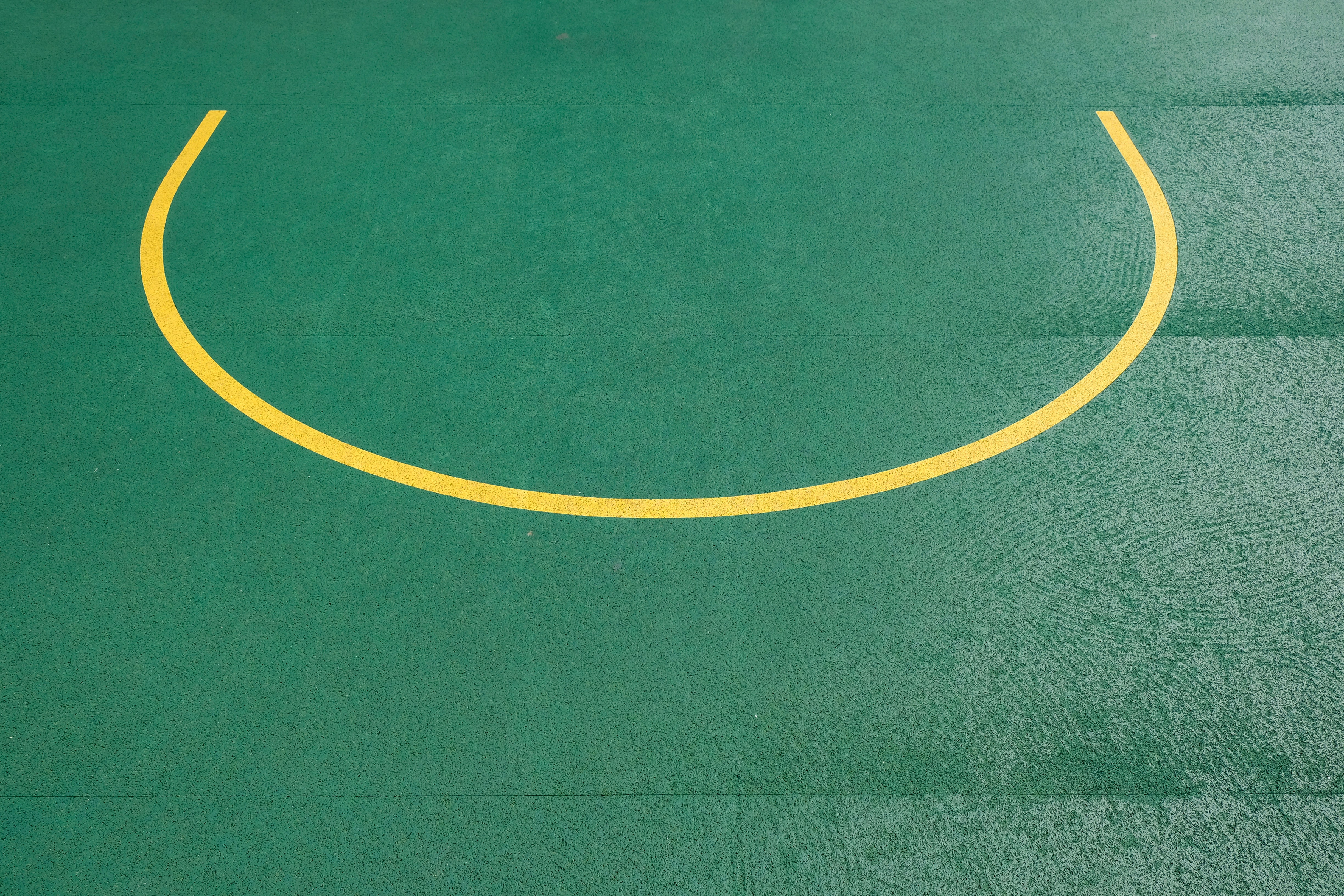 A tennis court with a smiley face painted on it