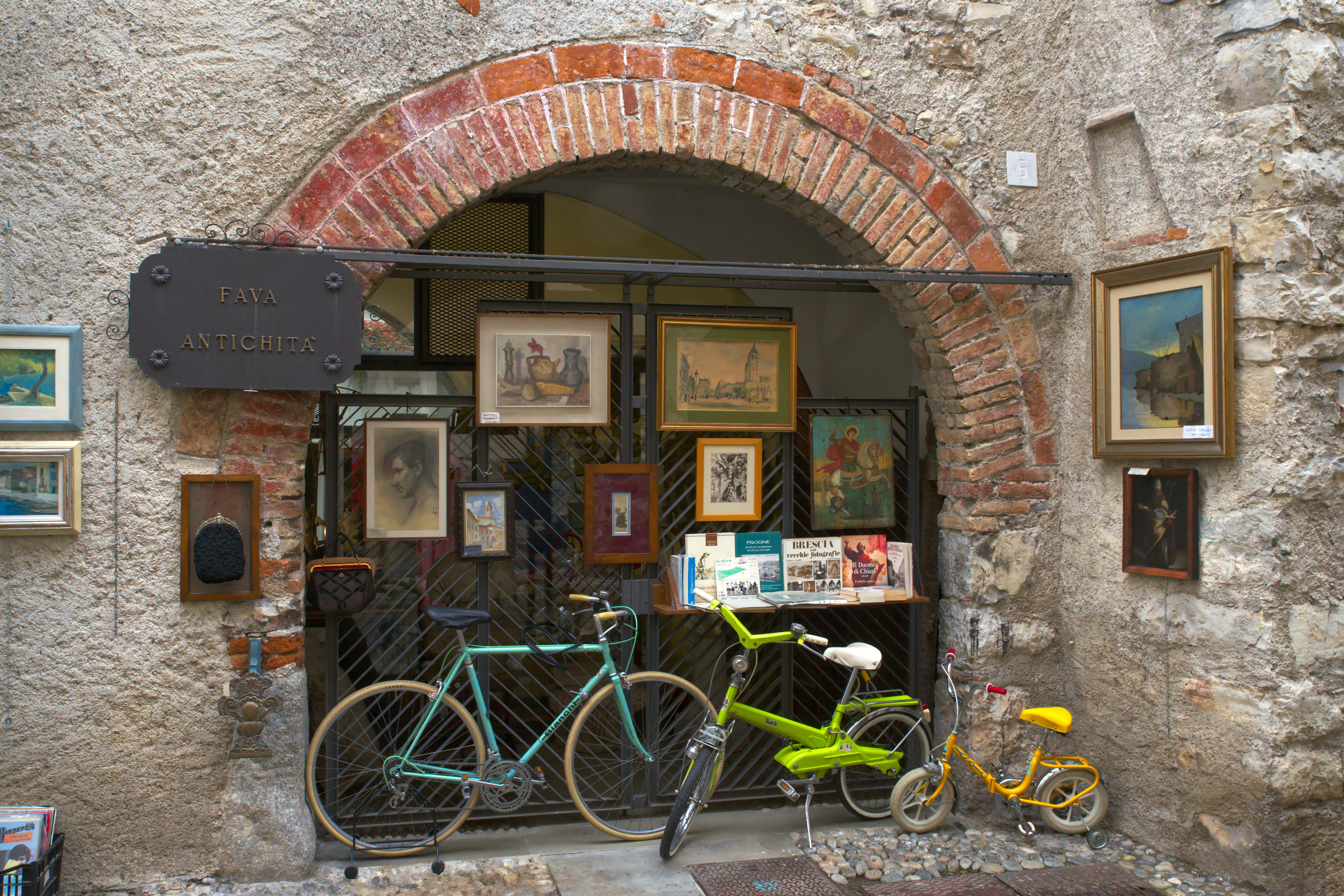 A couple of bikes parked in front of a building