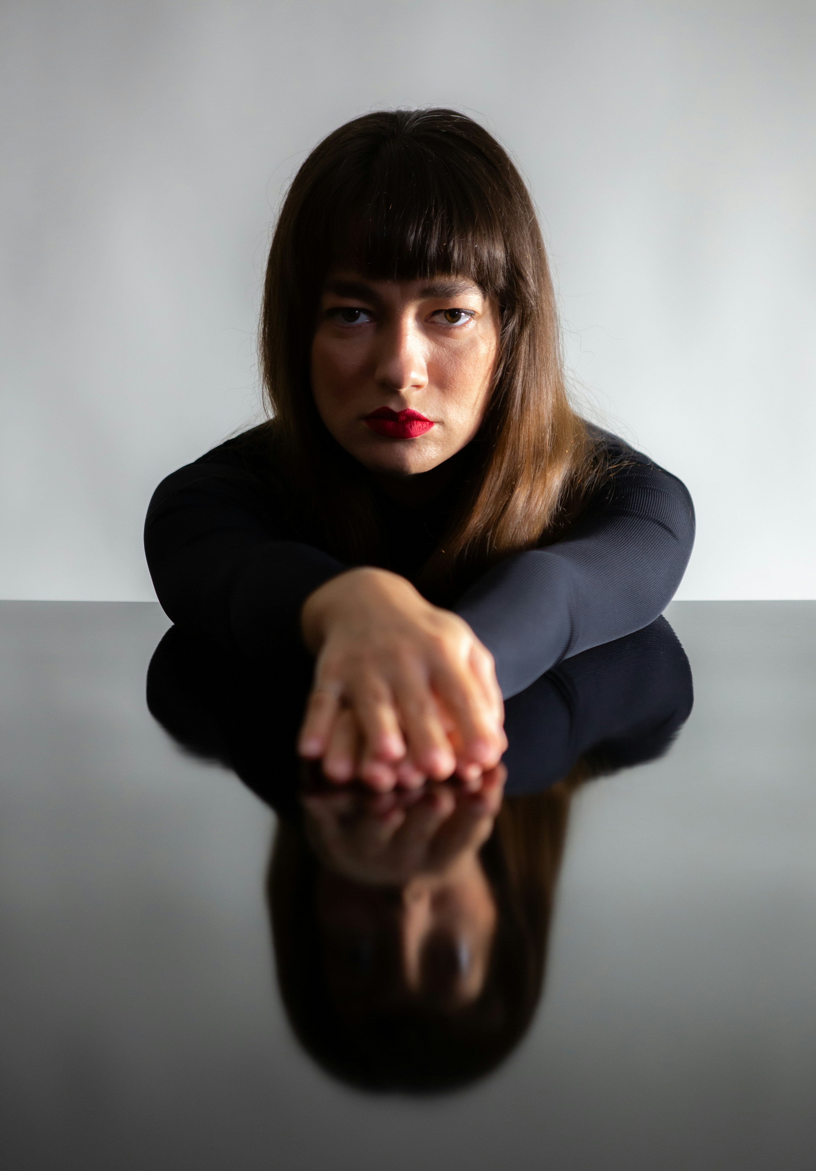 A woman sitting on the floor with her hand on her knees