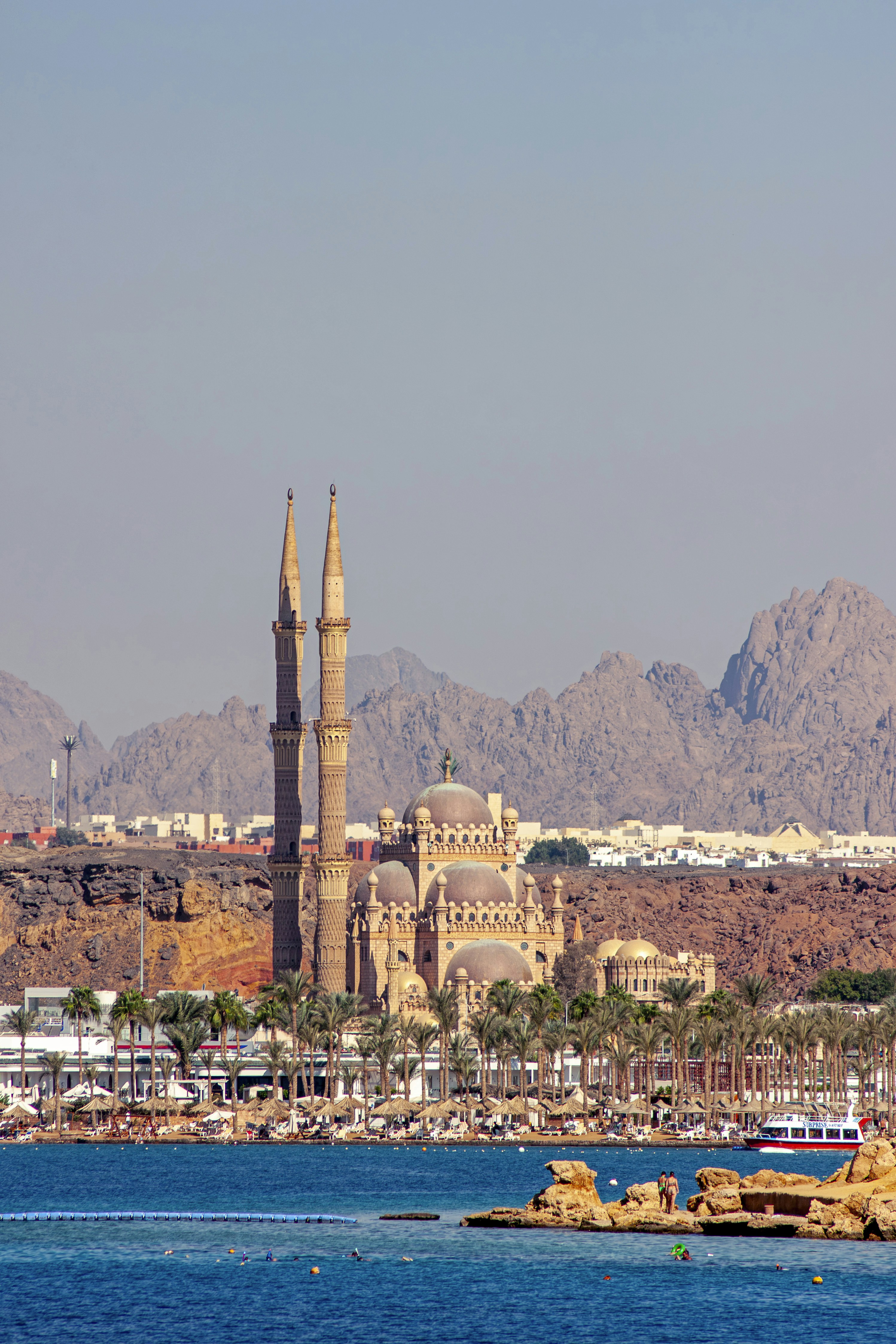 A large body of water with a city in the background