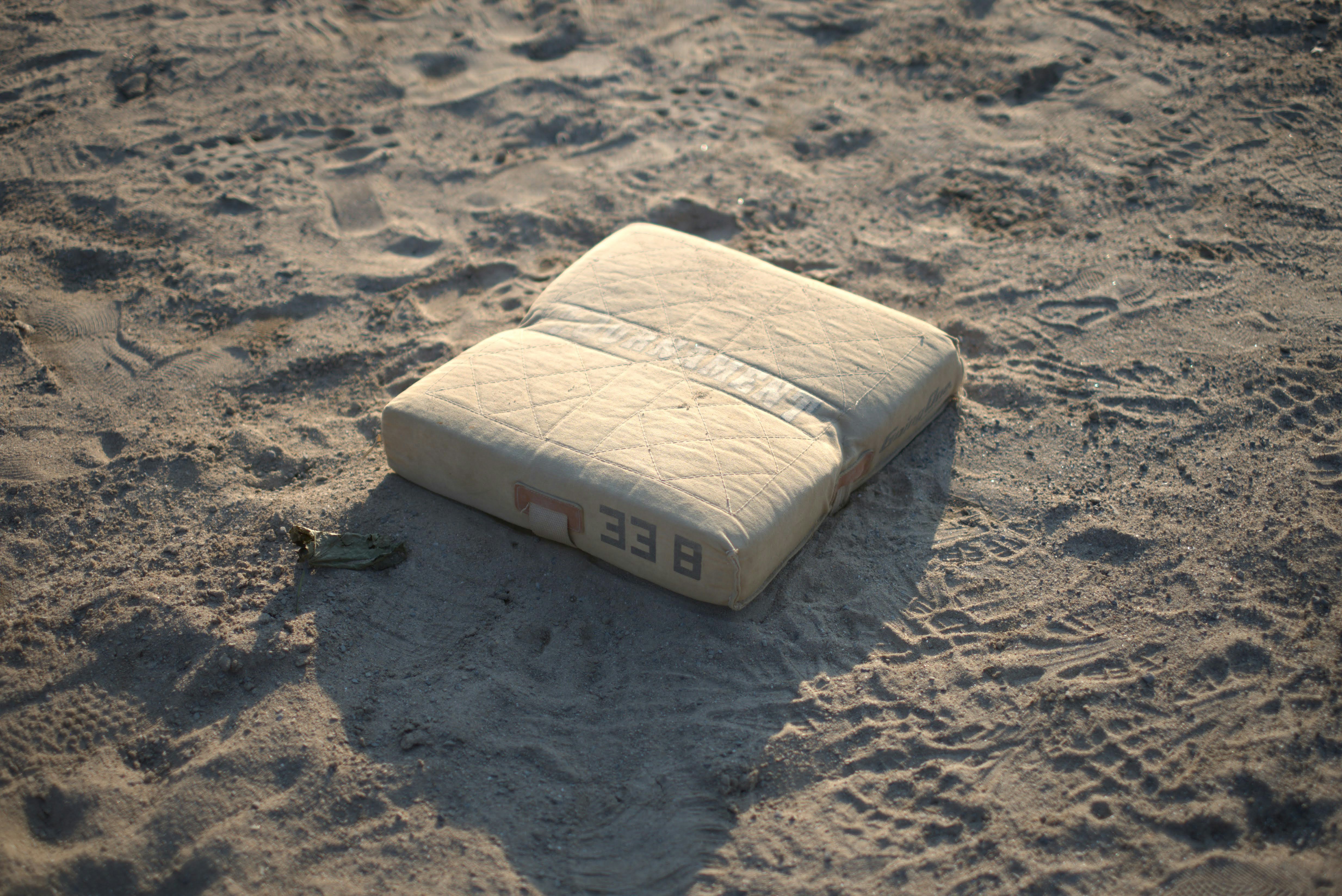 A white object laying on top of a sandy beach