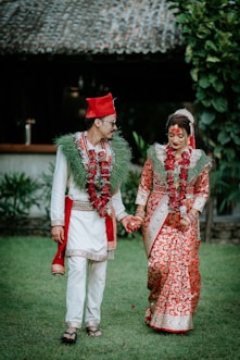 A bride and groom dressed in traditional indian garb
