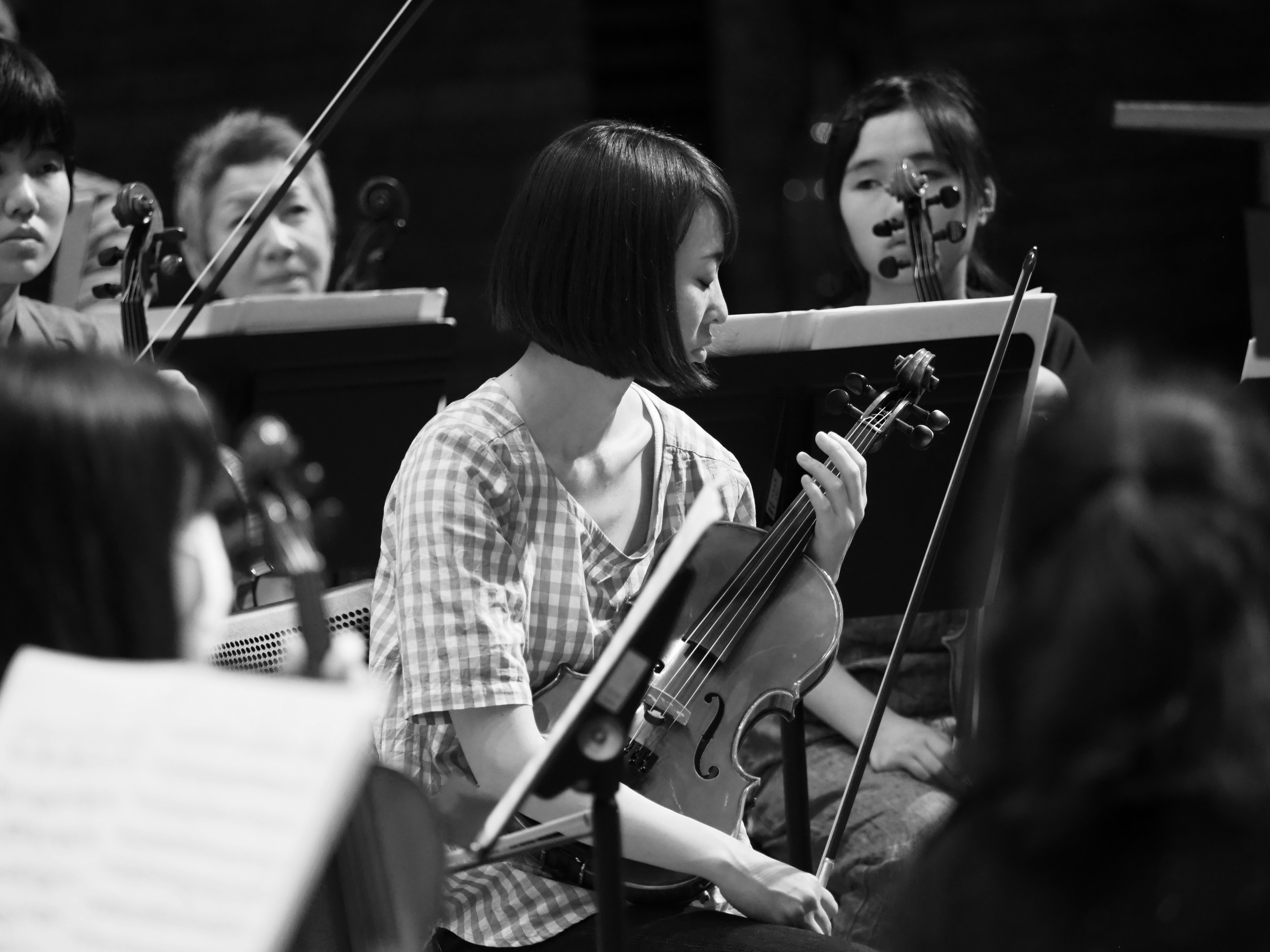 A group of people playing instruments in front of a crowd