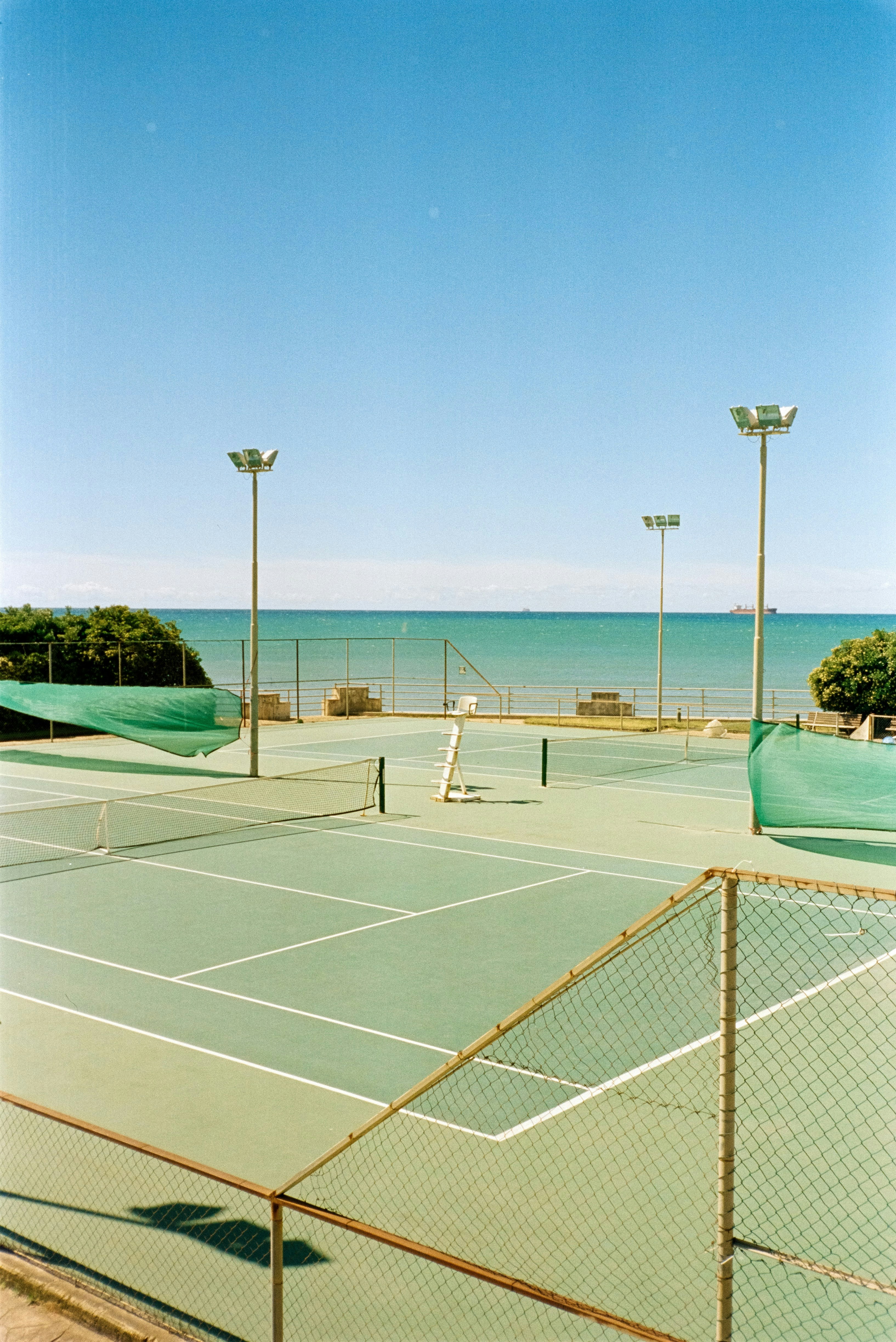 Sea-green tennis courts beside the Mediterranean in Salerno, Italy, photographed on film.